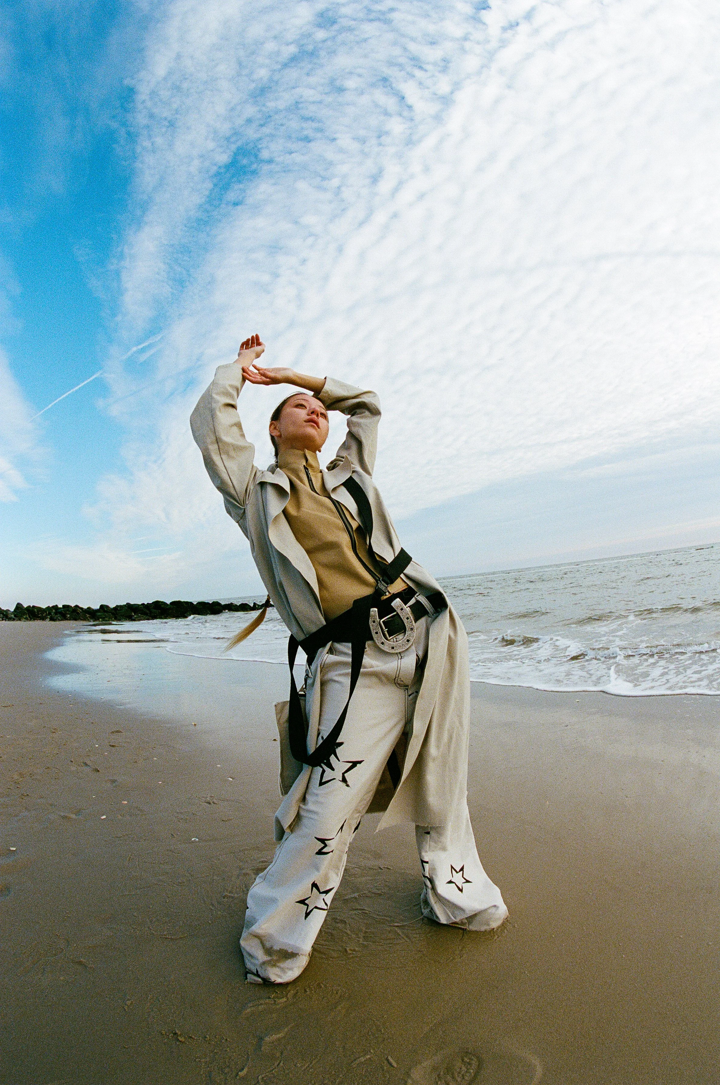 aisha zhanseit in flared star pant horseshoe belt canvas draped jacket and zip up top by conor odriscoll defective workwear 22 shot by thomas paul walsh new york city nyc rockaway