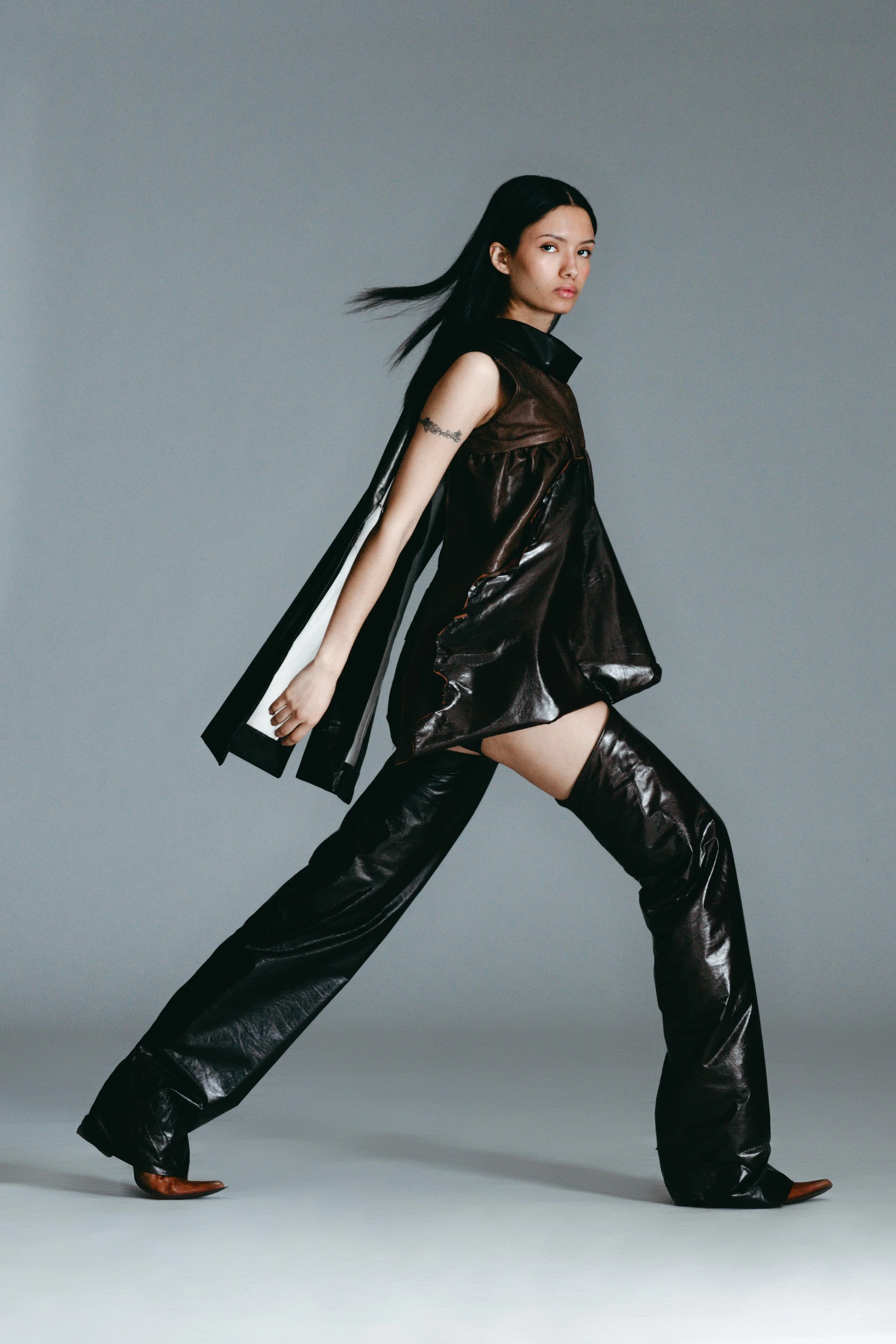 emmah in draped leather jacket, leather boxers, and leather garters by conor odriscoll. sexual narcissism collection, look 2 between the walls. shot by nico daniels. new york city