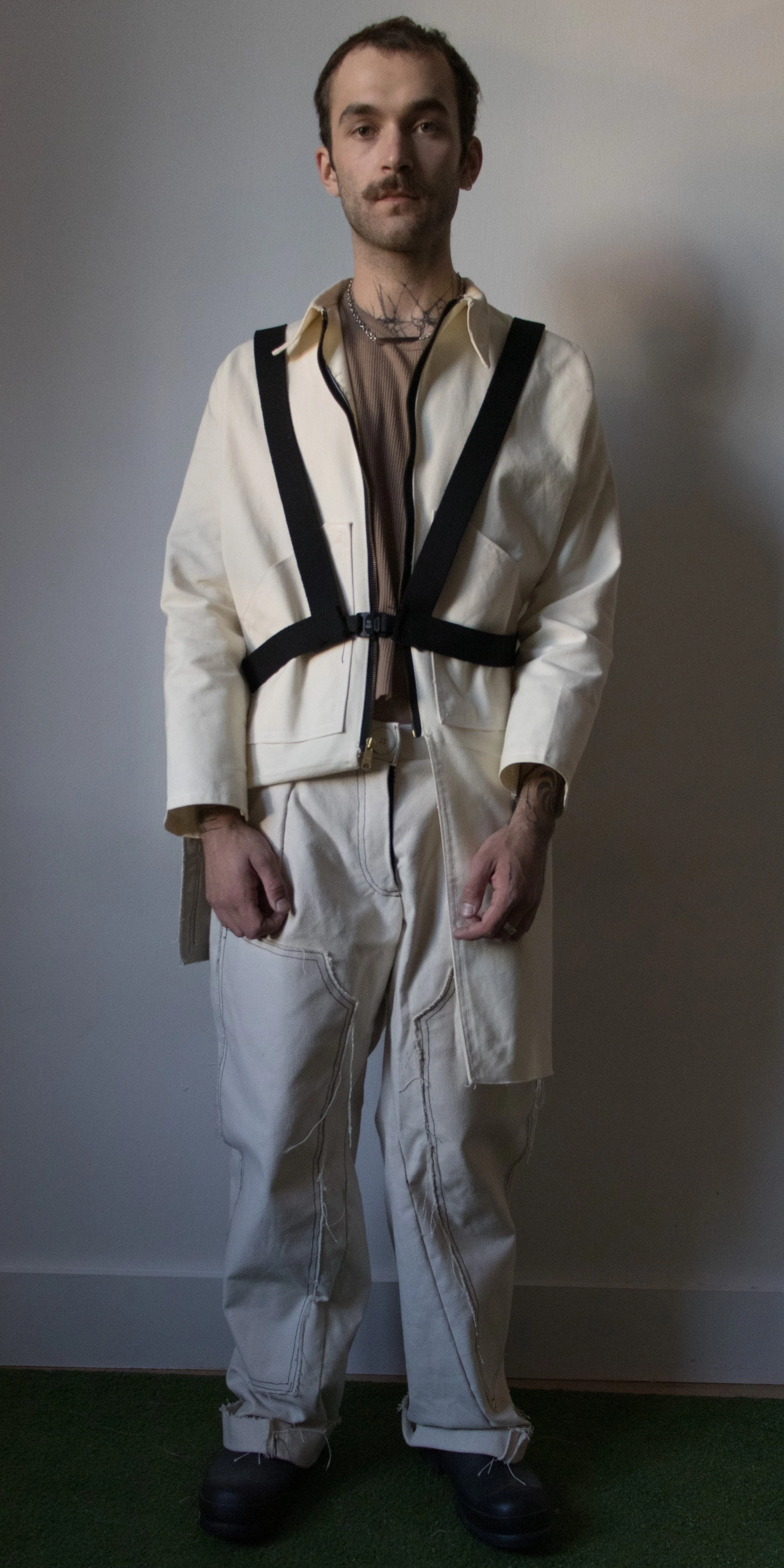 grant philips wearing adjustable canvas jacket/coat thermal knit tank top canvas pants by conor odriscoll defective workwear collection 2022