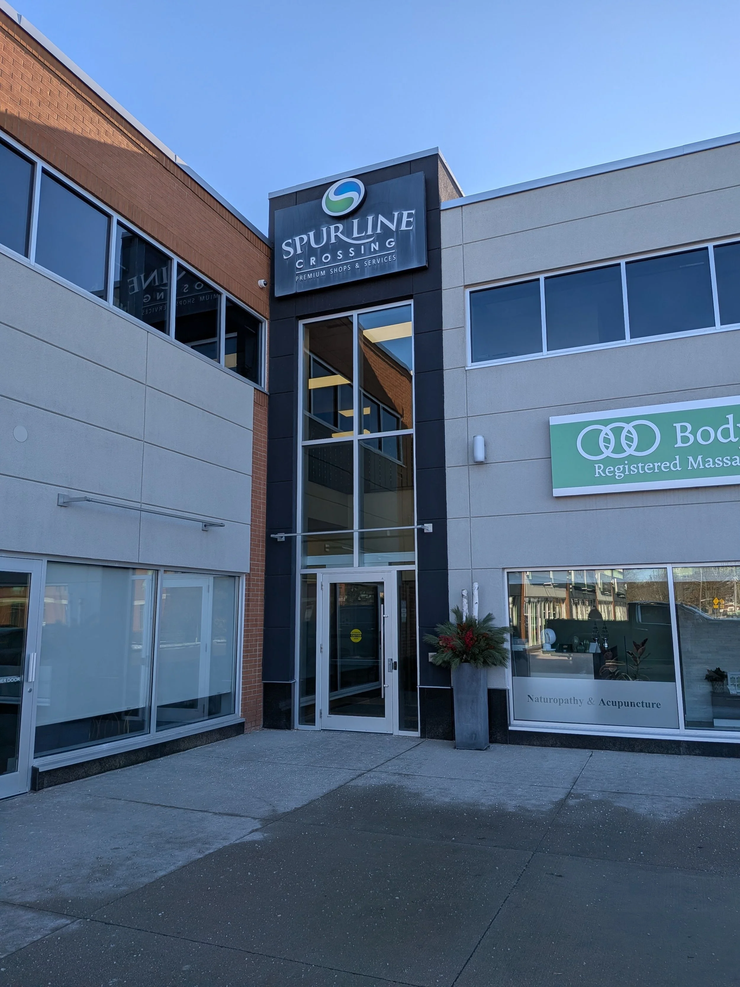 You may enter the building through the doors at the corner of the L (between Control Hair and Body Kinnection).