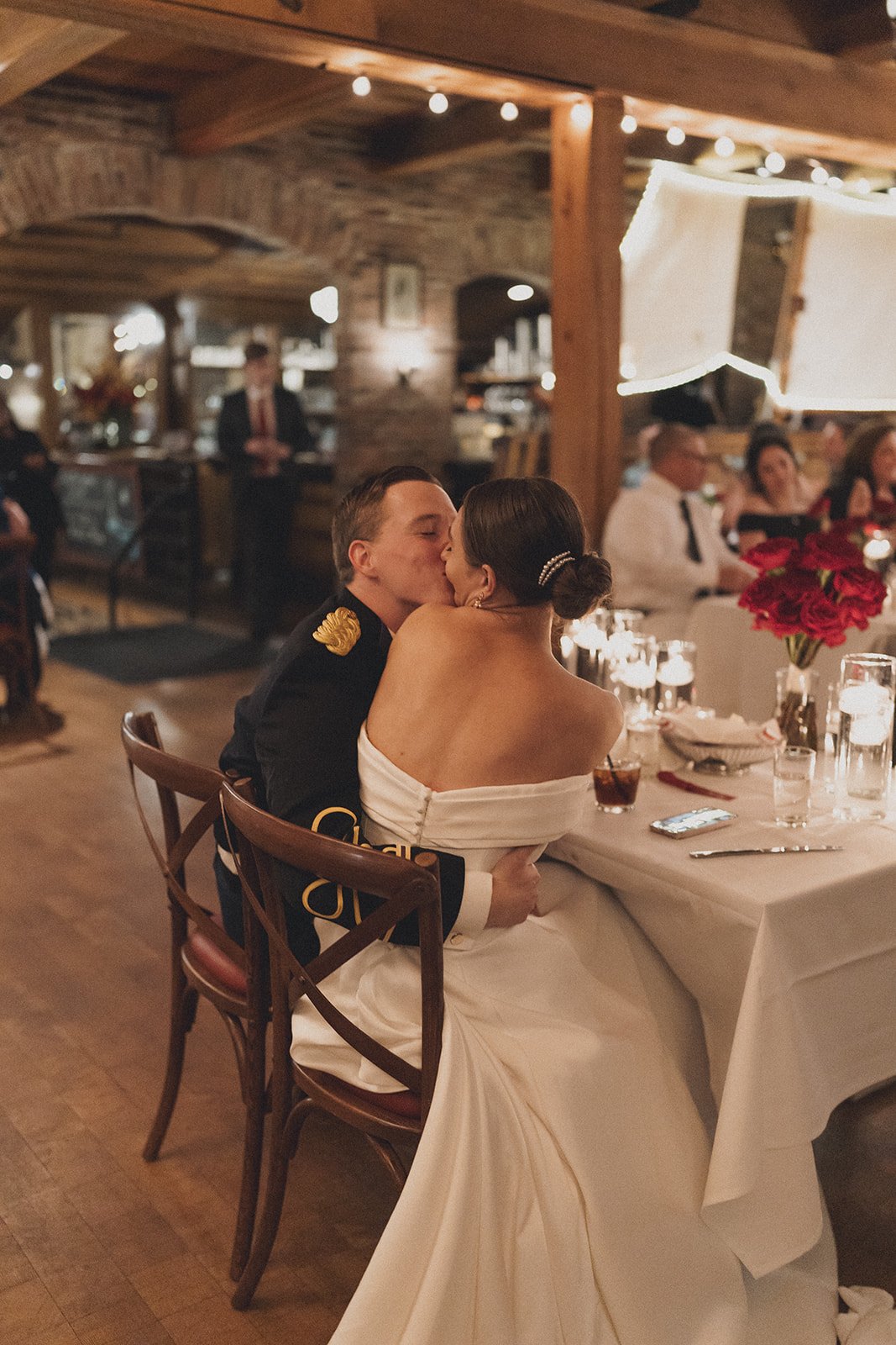 BRIDE GROOM KISSING WEDDING RECEPTION DINNER CANDLELIGHT RED ROSE