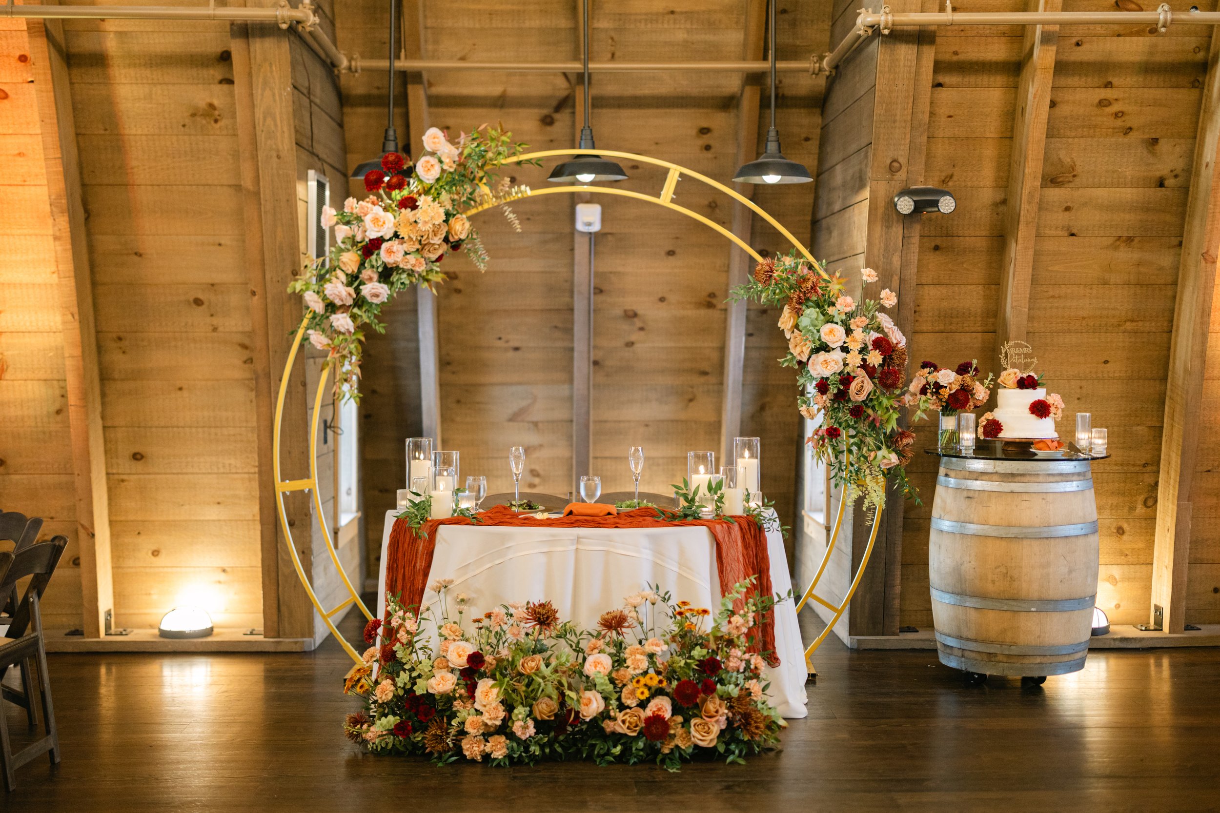 WEDDING RECEPTION SWEETHEART TABLE DECOR FLORAL ARCH FLOWER GROUND ARRANGEMENT FALL PEACH BLUSH MAROON SWEENEY BARN