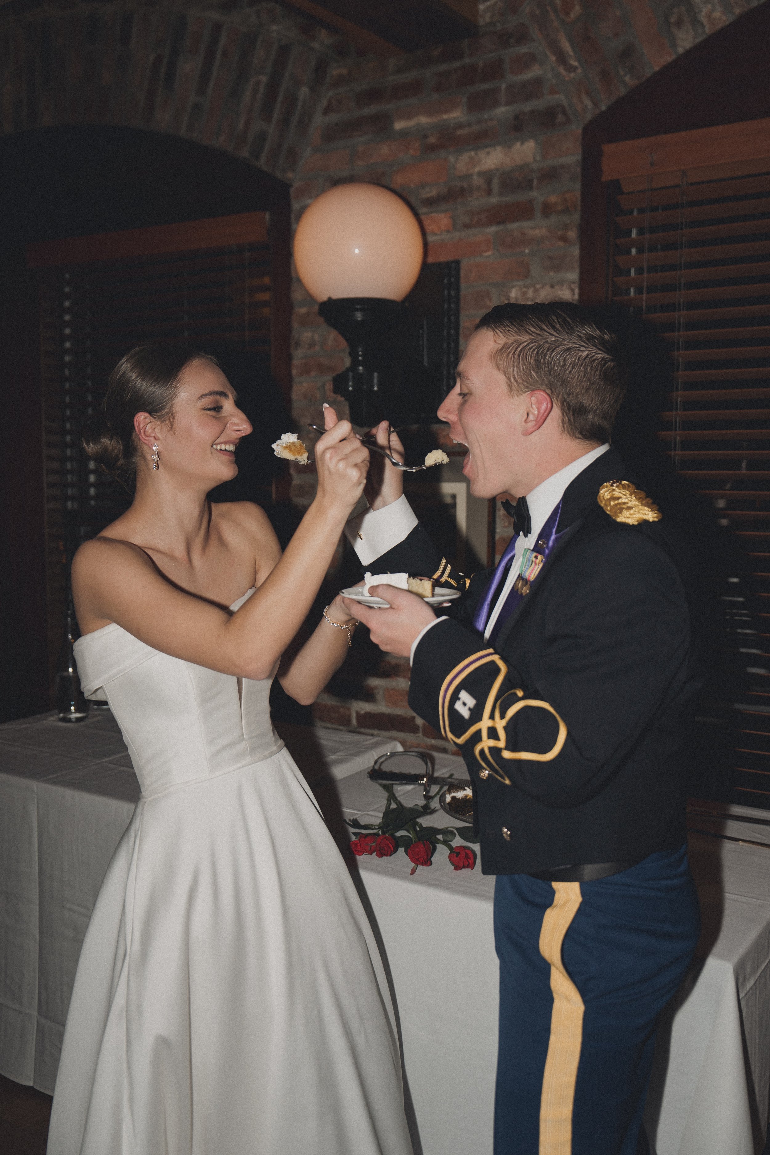 BRIDE GROOM FEEDING EACH OTHER WEDDING CAKE