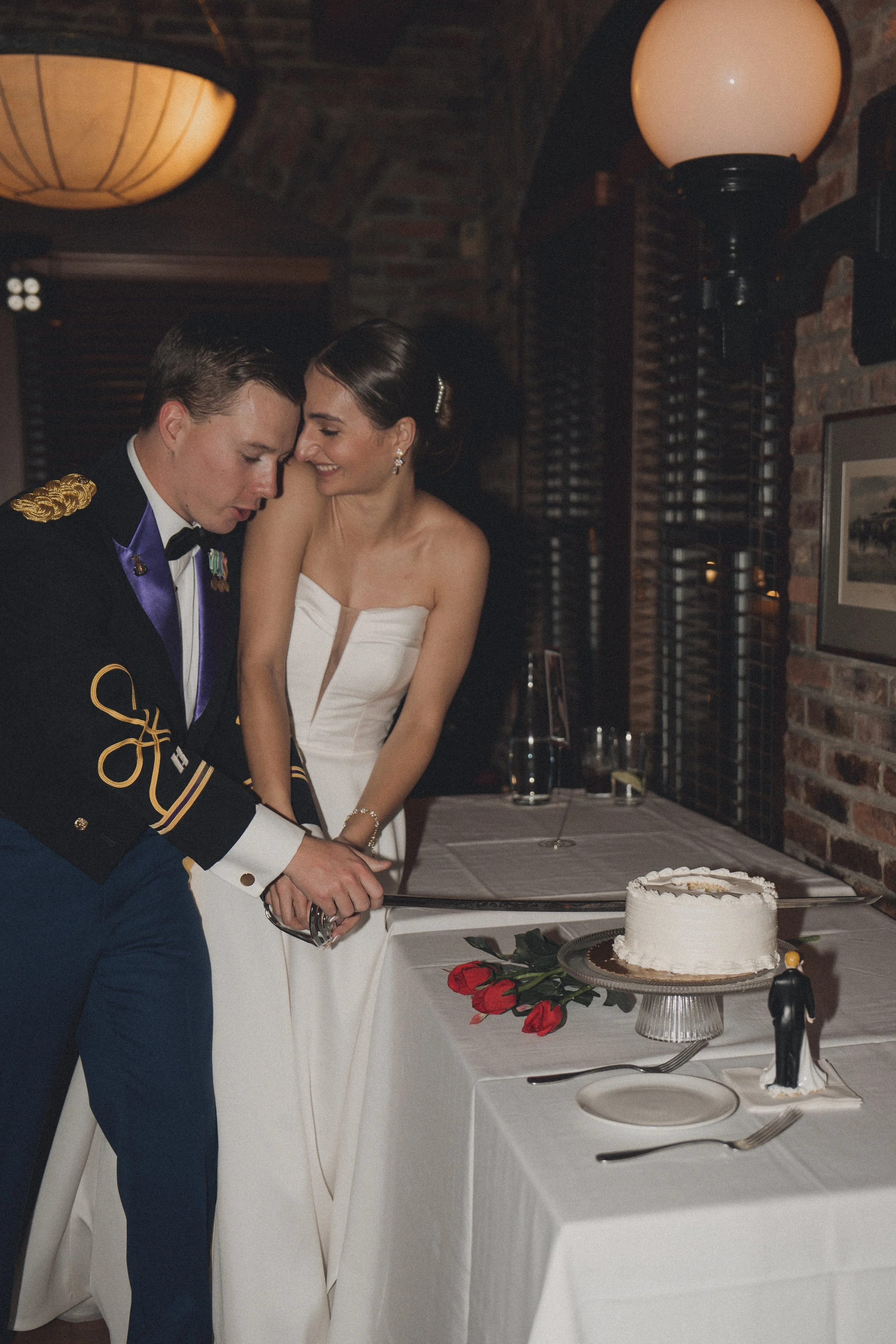 BRIDE GROOM CUTTING WEDDING CAKE