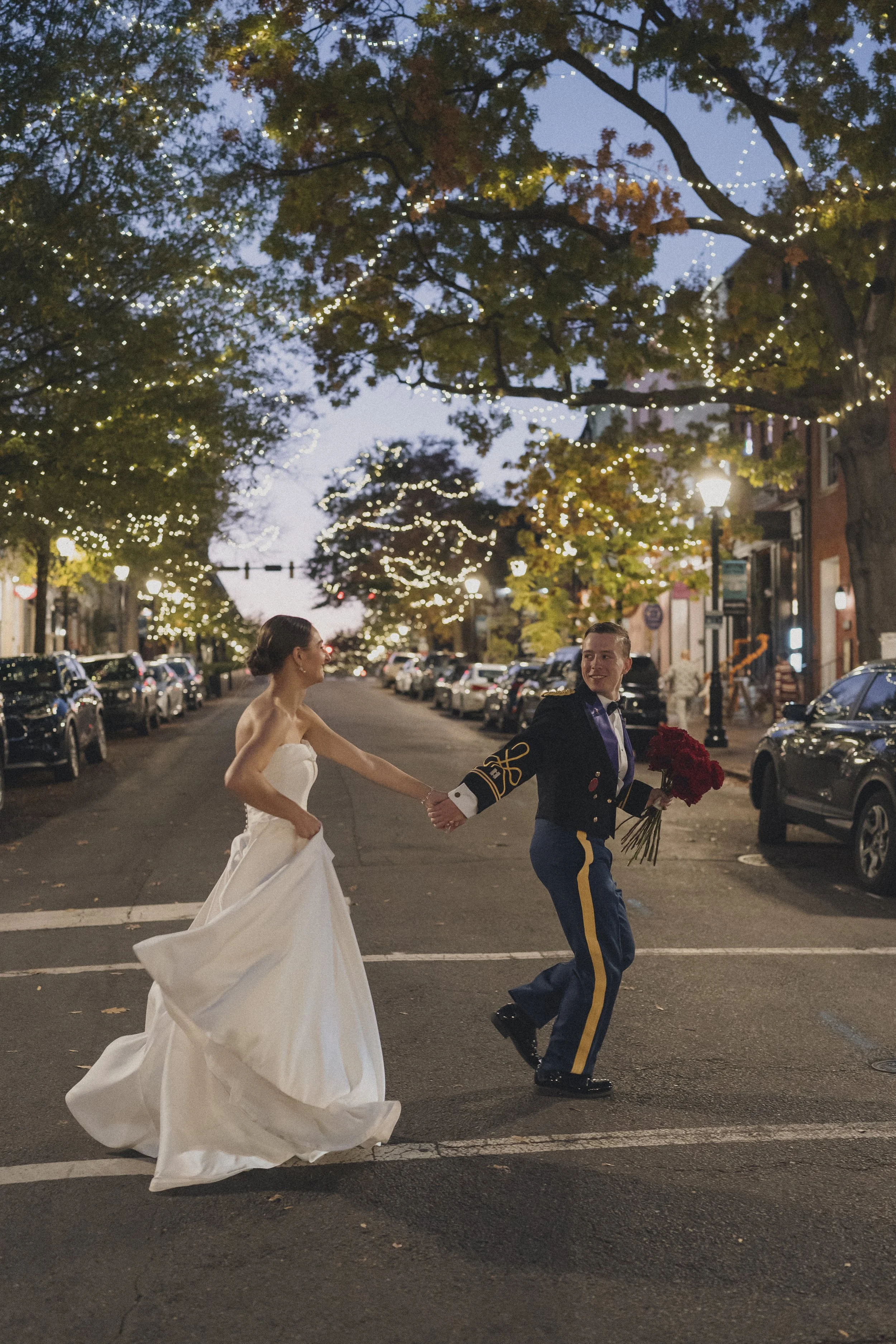 BRIDE GROOM RED ROSE BRIDAL BOUQUET RUNNING THROUGH STREET OLD TOWN ALEXANDRIA VIRGINIA