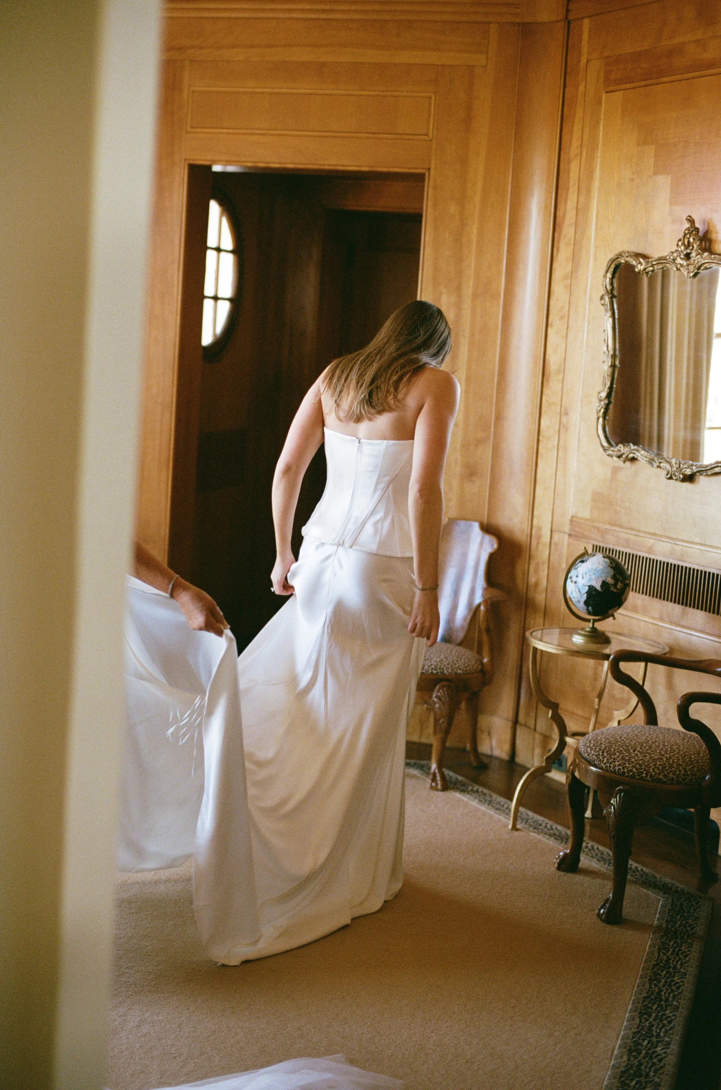BRIDE TRYING ON WEDDING DRESS GOODSTONE INN RESTAURANT