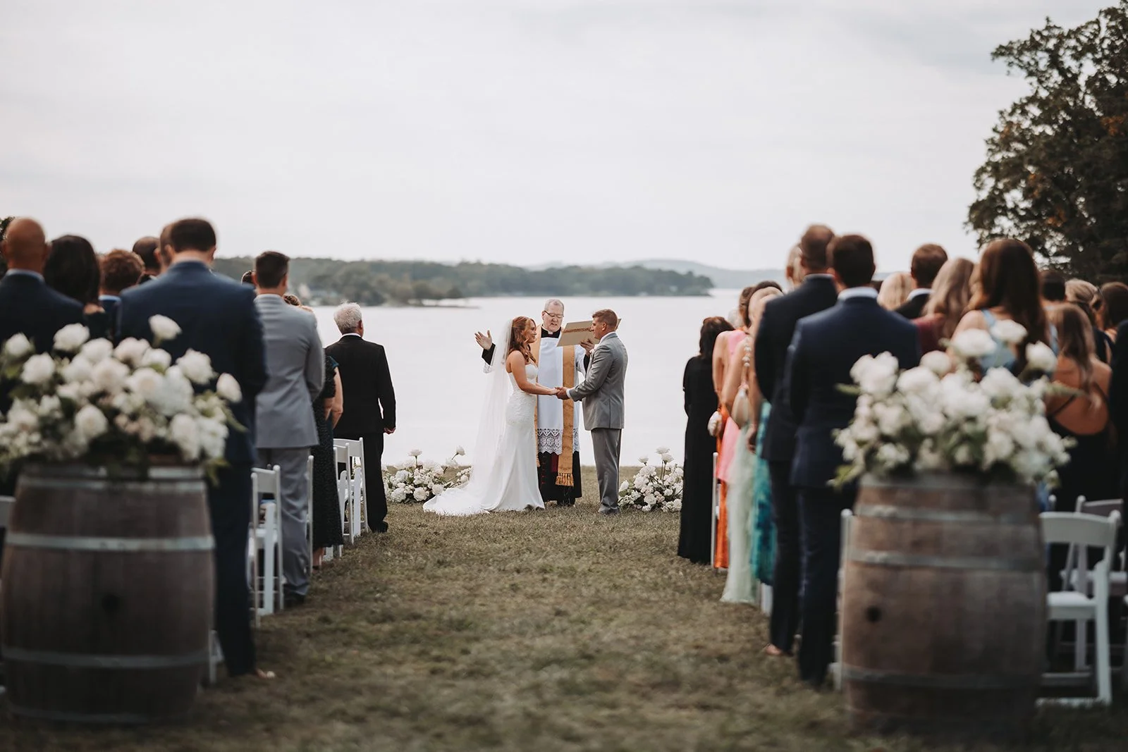 bride groom ground flowers wine barrel floral arrangement aisle catholic wedding ceremony bohemia manor farm chesapeake city maryland