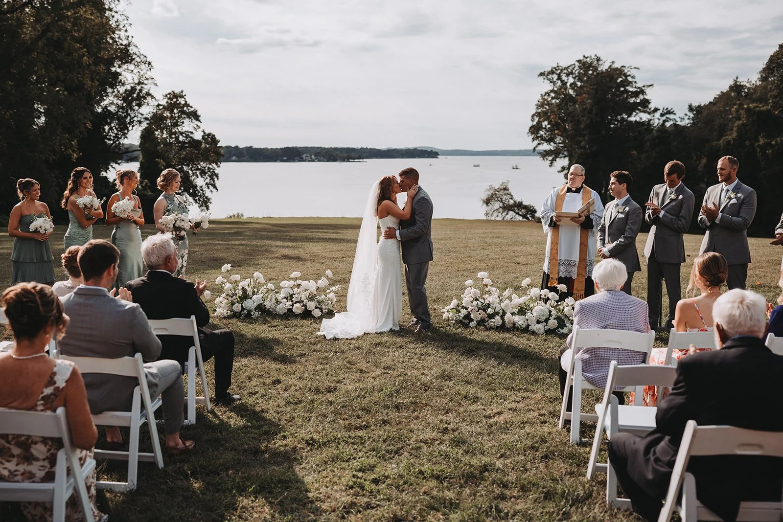 bride groom kiss ground flowers floral arrangement aisle catholic wedding ceremony bohemia manor farm chesapeake city maryland