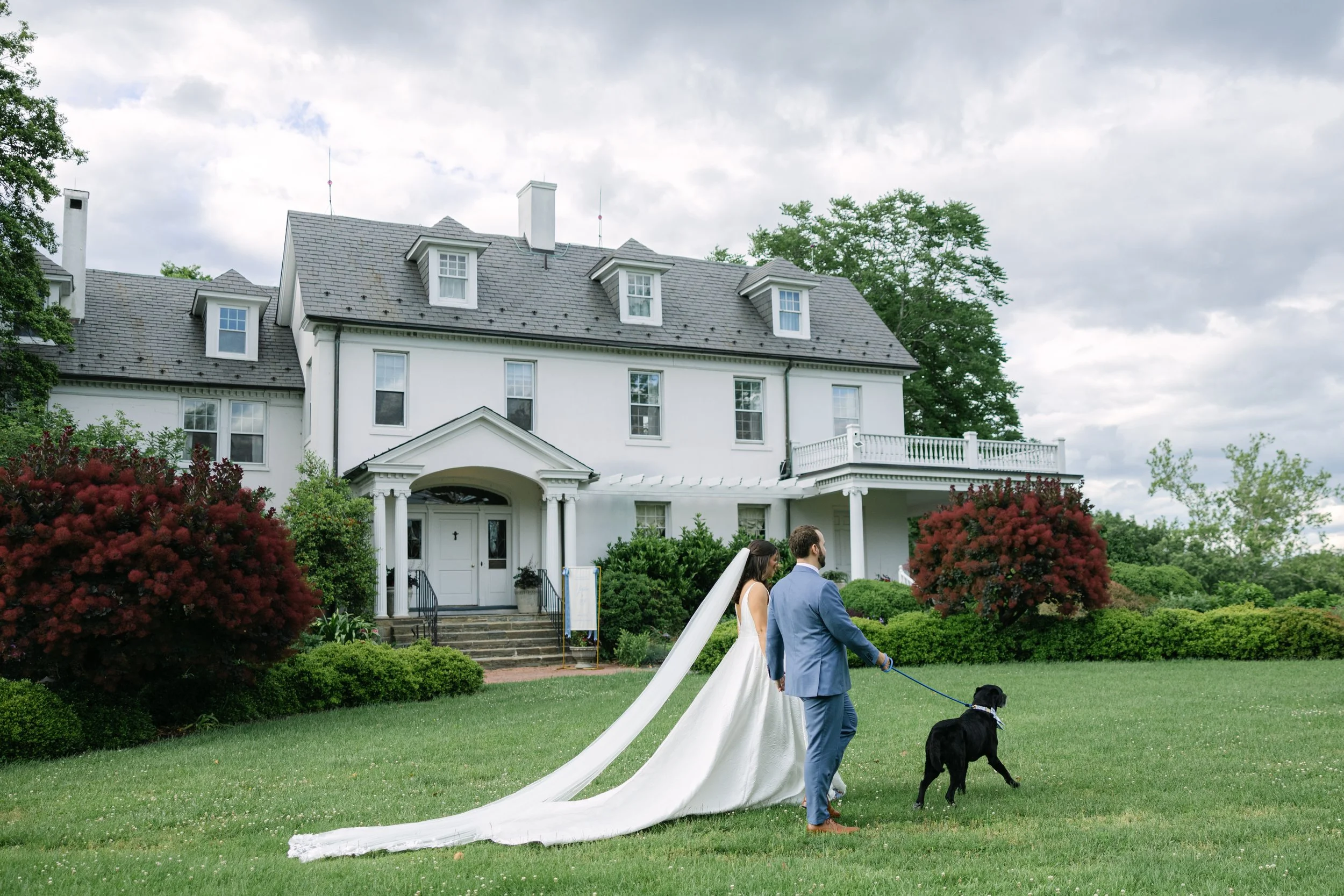 BRIDE GROOM WALKING DOG RIVER FARM WEDDING CEREMONY