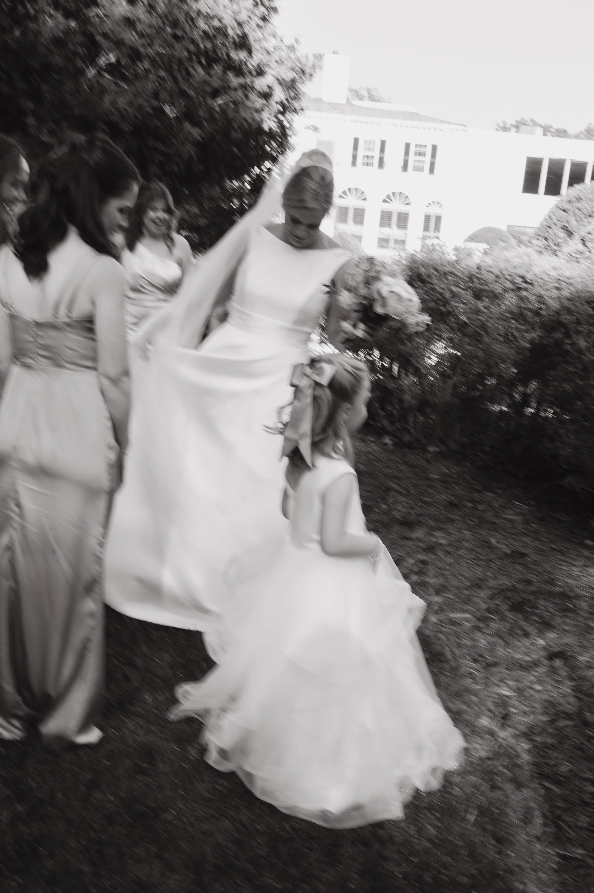 BLACK WHITE BRIDE HOLDING BOUQUET WITH FLOWER GIRL