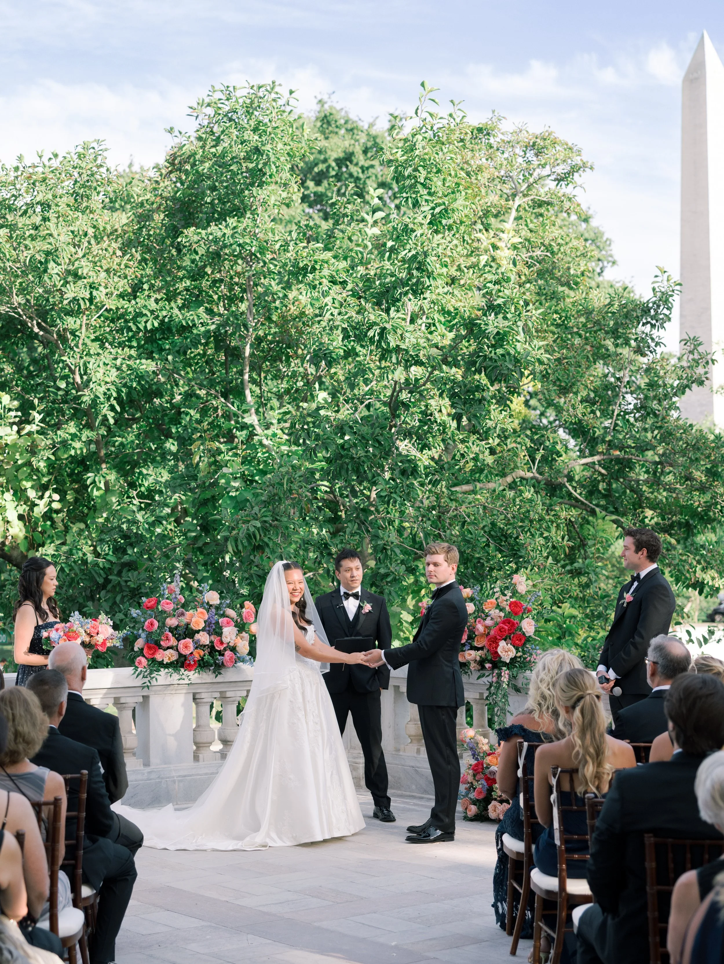 BRIDE GROOM WEDDING CEREMONY FLORAL DESIGN FLOWERS ARCH WASHINGTON DC MONUMENT DAR DAUGHTERS AMERICAN REVOLUTION VIBRANT BOLD
