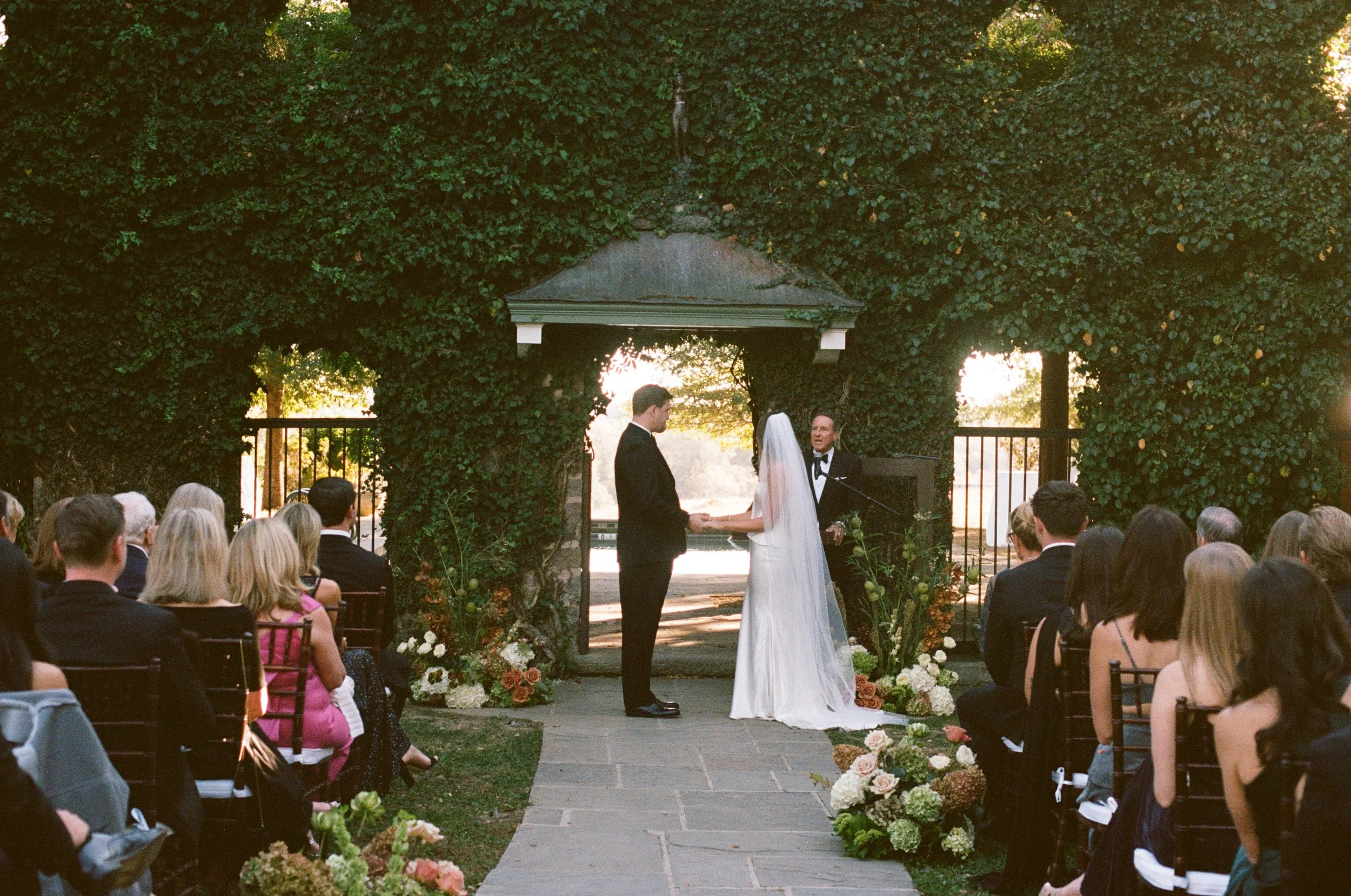 bride groom autumn wedding ceremony aisle floral arrangements goodstone inn and restaurant hunt country virginia