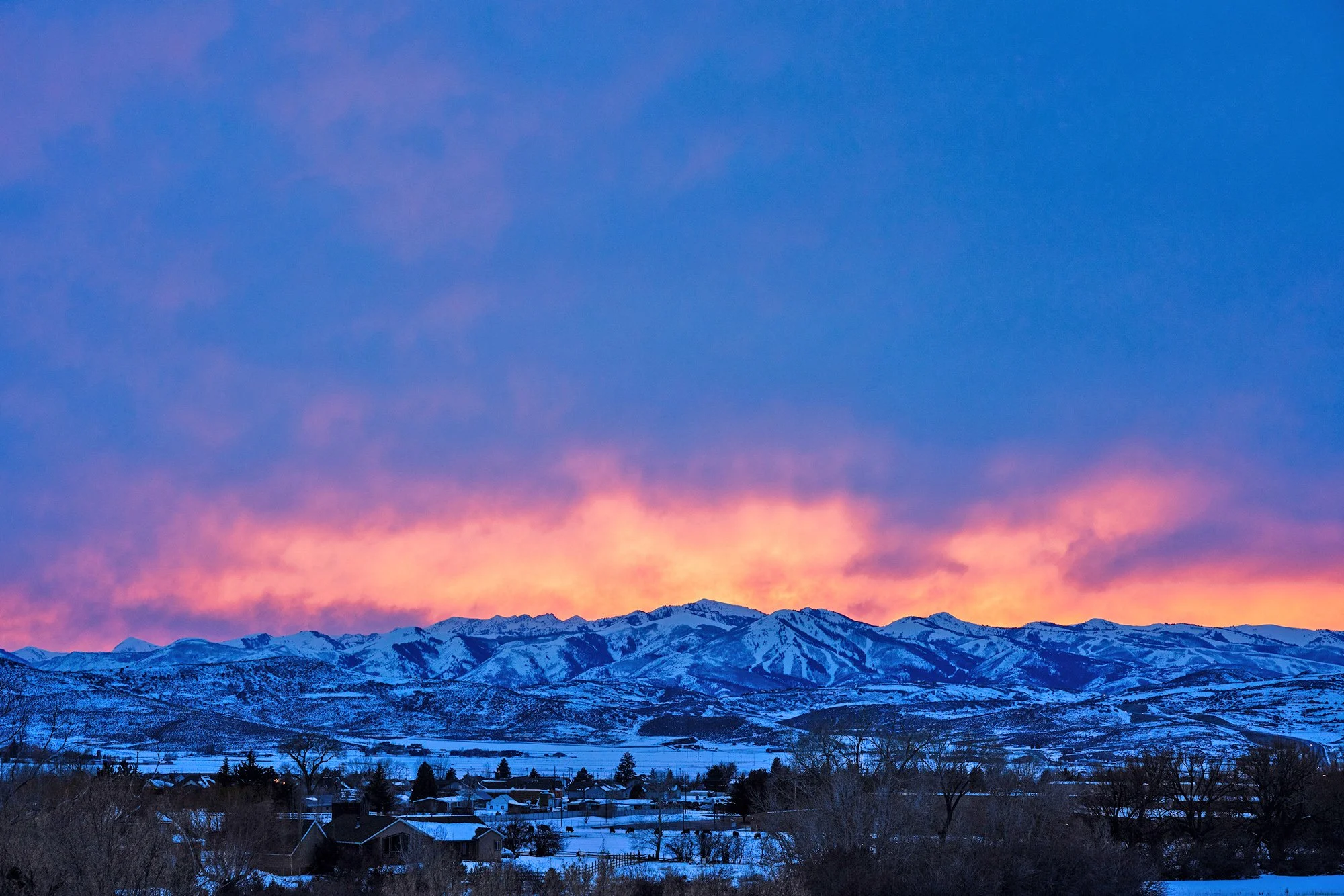 Aerial view of Kamas Utah luxury mountain homes, HOA communities, ranch properties, and recreation corridors needing premium asphalt paving, sealcoating, crack sealing, and long‑term pavement maintenance services
