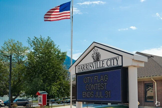 Harrisville Utah City Hall with American flag, located near residential and commercial areas served by asphalt paving, repair, and maintenance services.