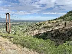Draper City Bear Canyon Trail bridge and the surrounding foothill skyline — representing local asphalt paving, repair, and maintenance services.