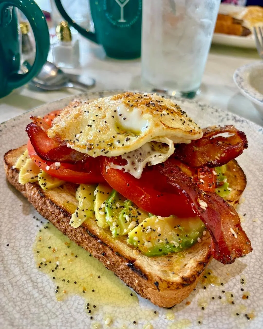 Avocado Toast lookin' fancy today 💅

All dressed up with ripe tomato slices, crispy bacon, and an over easy egg. Happy #NationalAvocadoDay! 🥑