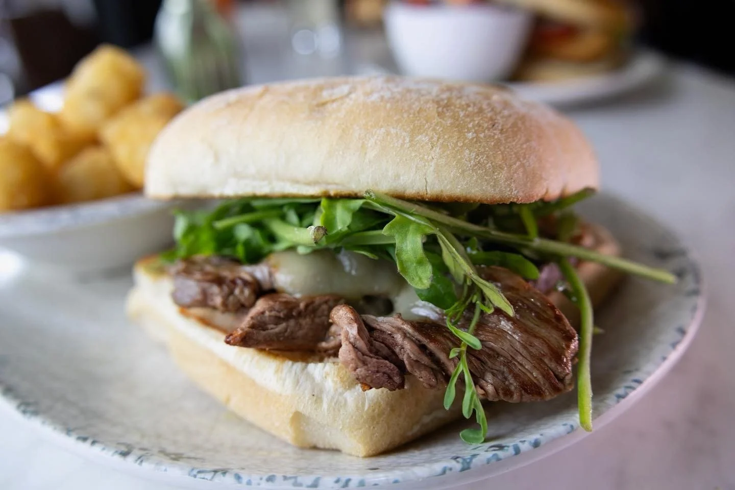 Sliced filet, caramelized onion, melty muenster cheese, arugula + mayo on ciabatta. You hungry yet? 🤤

Get lunch delivered! Order through our website.