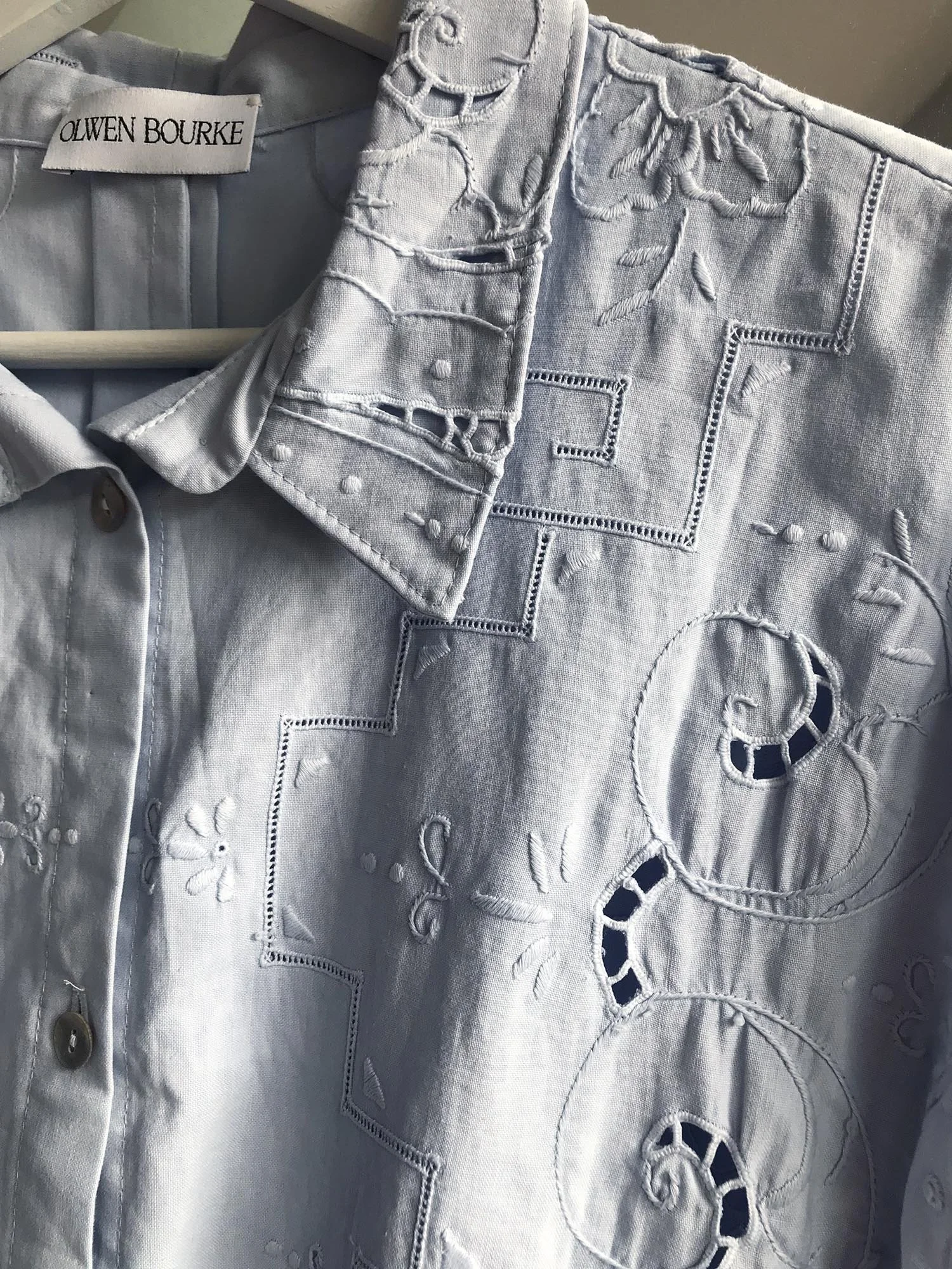 Short sleeved cotton shirt, up-cycled from an antique, hand embroidered table cloth and dyed by hand to a pale blue colour. Shell buttons and cropped length