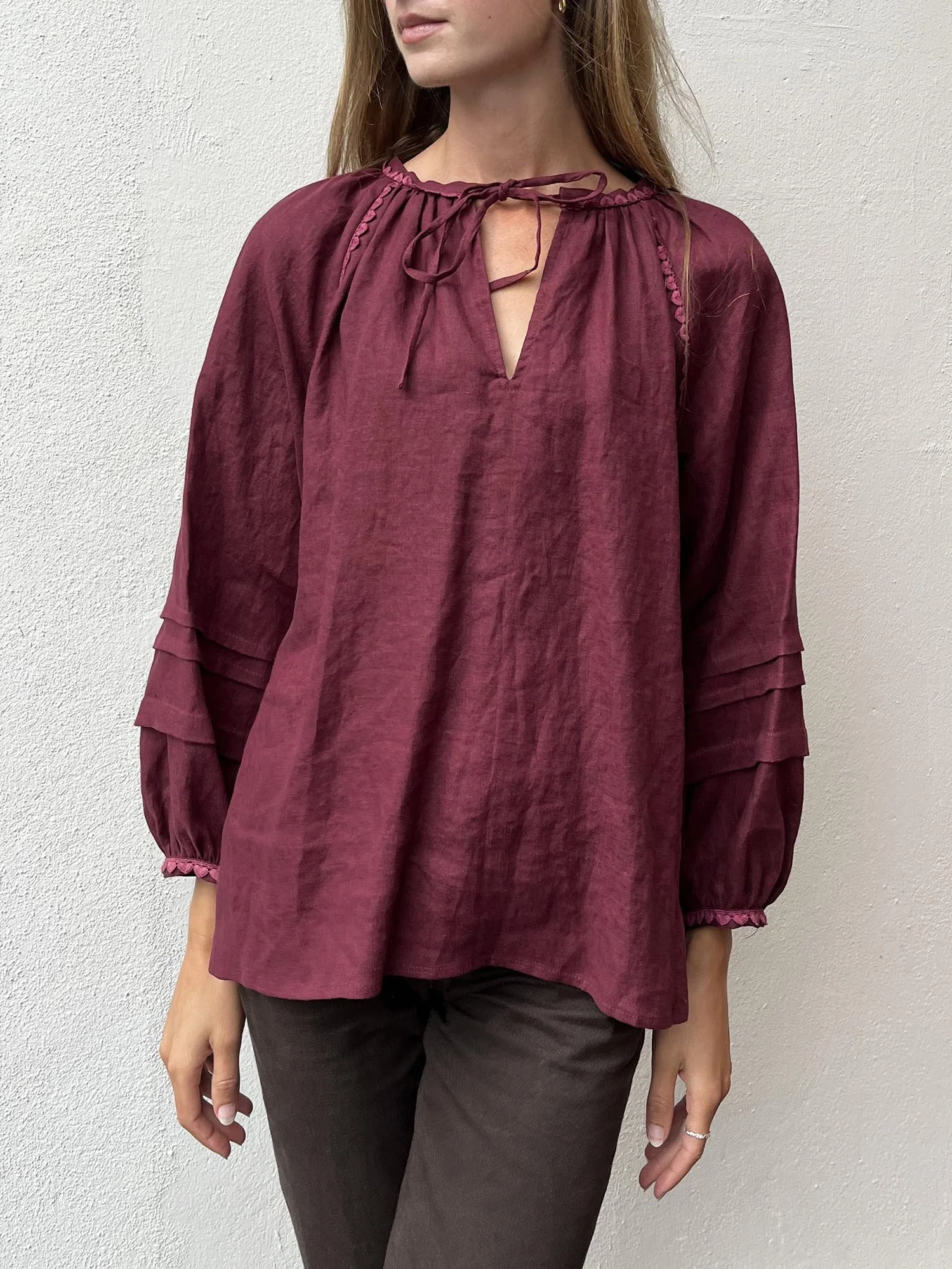 Burgundy coloured, long sleeve, Irish linen blouse with pink antique lace details and ties at front