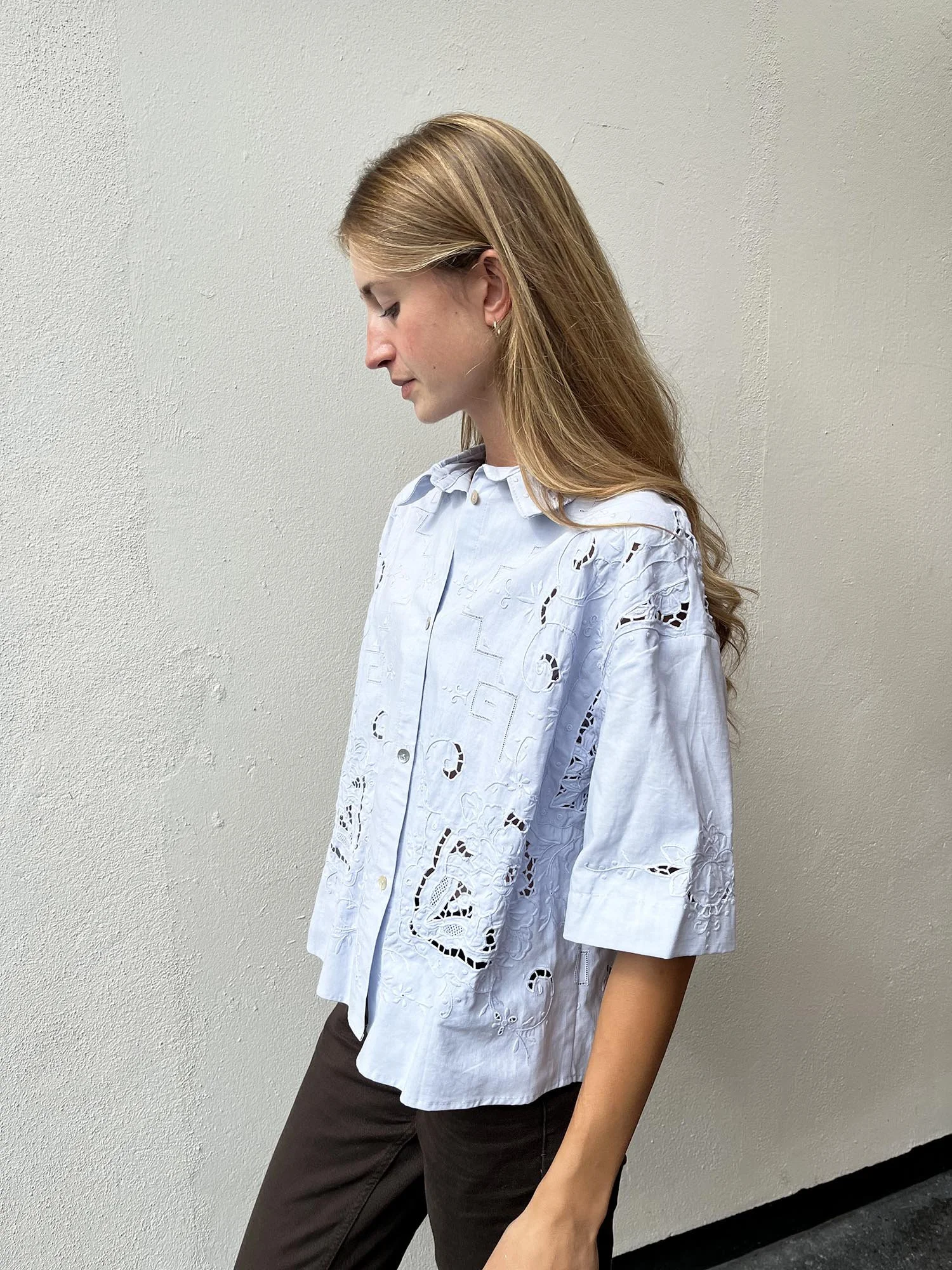 Short sleeved cotton shirt, up-cycled from an antique, hand embroidered table cloth and dyed by hand to a pale blue colour. Shell buttons and cropped length