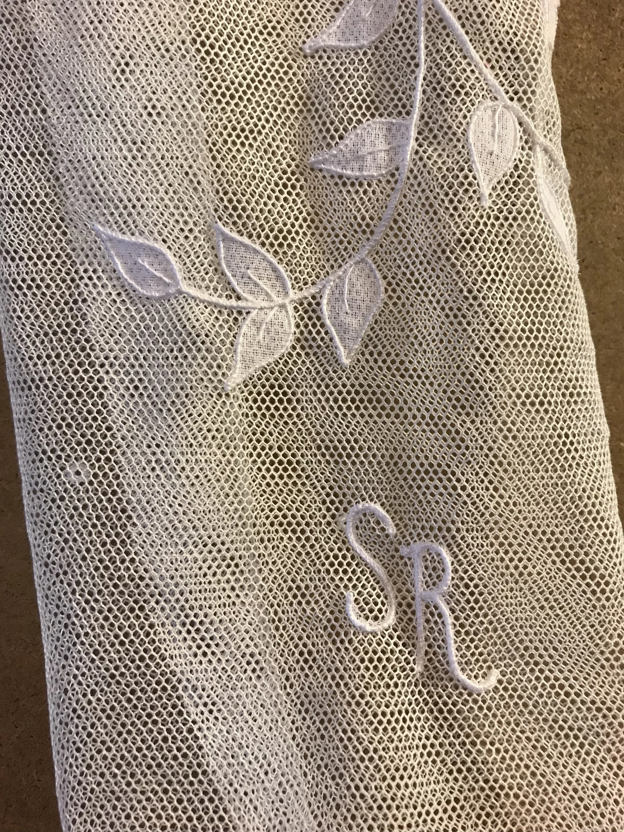 Custom monogram initials embroidered onto a bespoke Carrickmacross Irish lace wedding topper