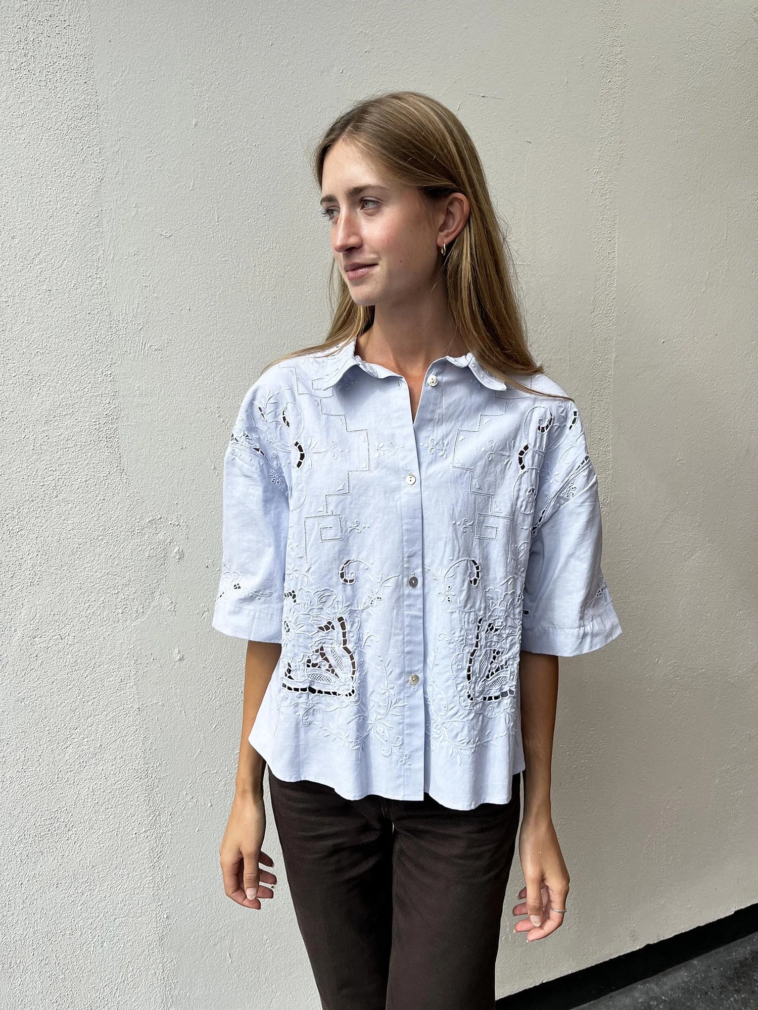 Short sleeved cotton shirt, up-cycled from an antique, hand embroidered table cloth and dyed by hand to a pale blue colour. Shell buttons and cropped length