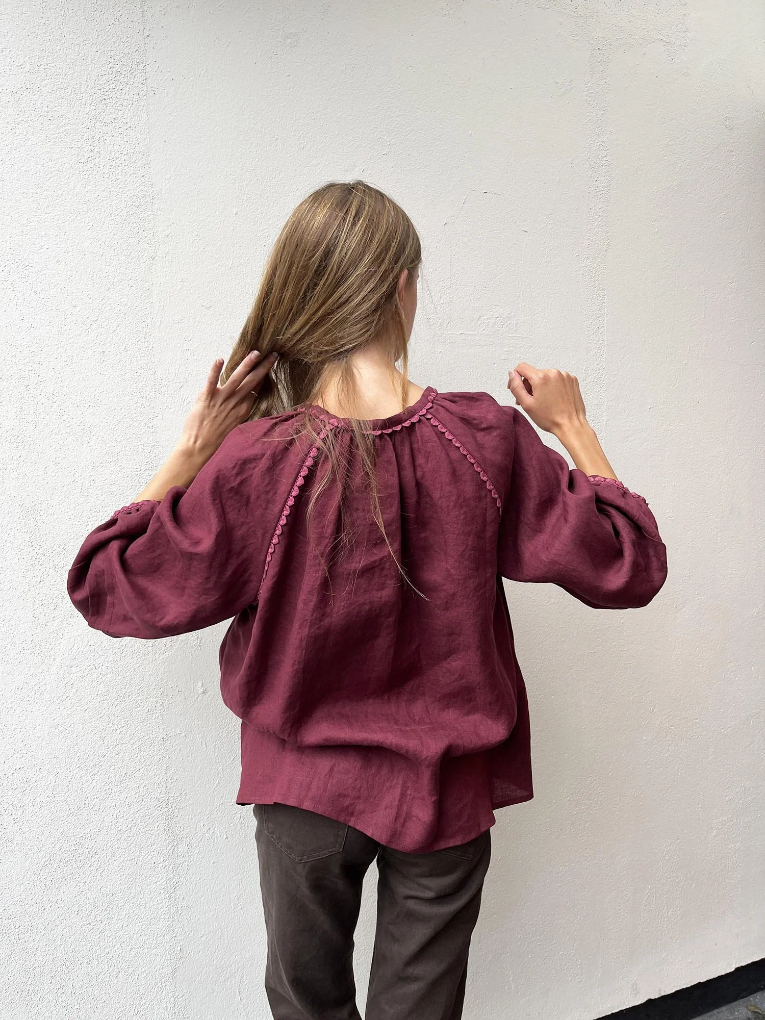 Burgundy coloured, long sleeve, Irish linen blouse with pink antique lace details and ties at front