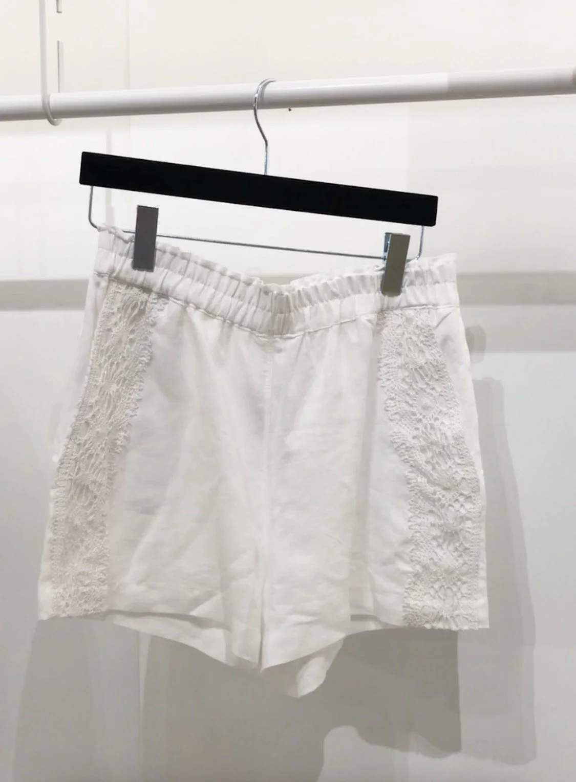 White Irish linen shorts with pockets and vintage lace details.