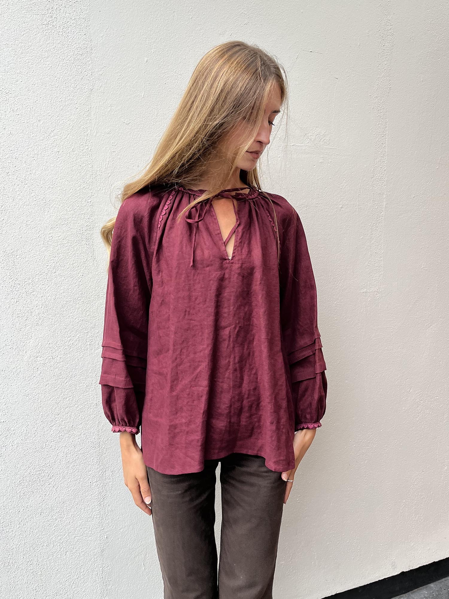 Burgundy coloured, long sleeve, Irish linen blouse with pink antique lace details and ties at front
