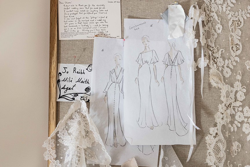 Bridal mood board with wedding dress sketches, lace samples and thank you notes