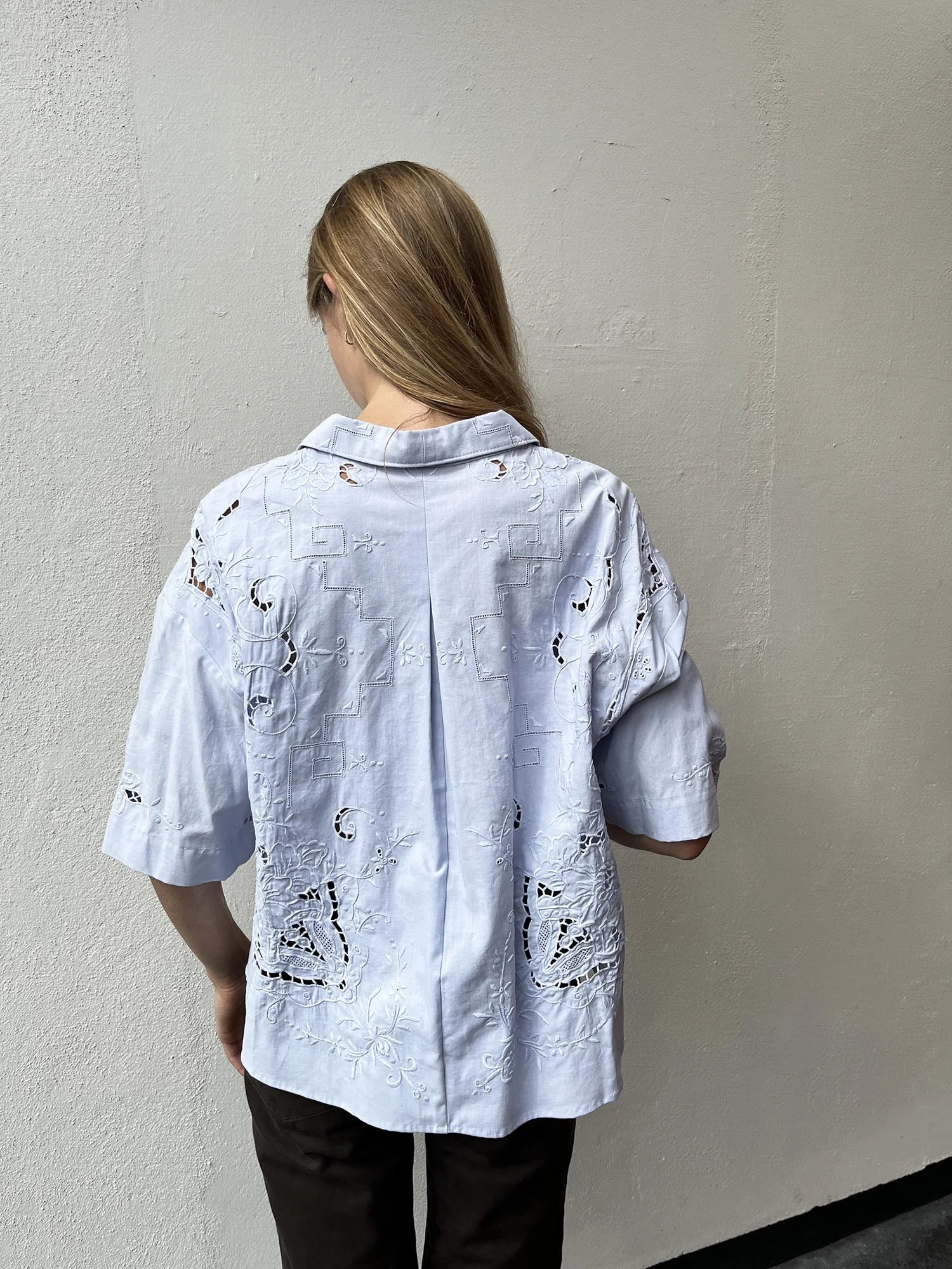 Short sleeved cotton shirt, up-cycled from an antique, hand embroidered table cloth and dyed by hand to a pale blue colour. Shell buttons and cropped length