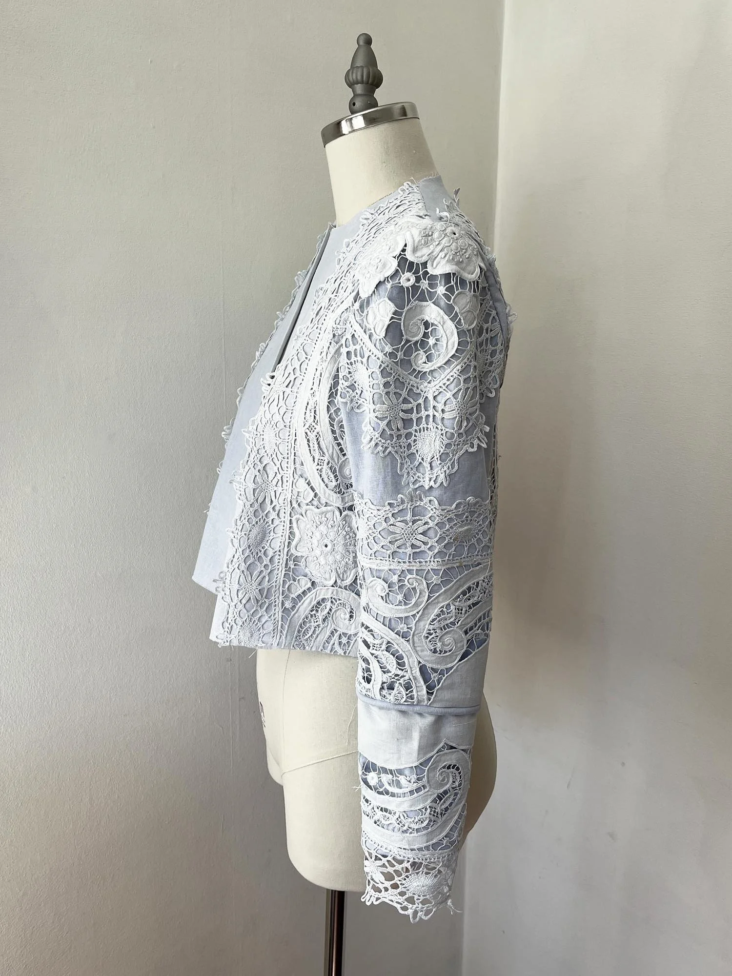 Pale blue cropped jacket made from linen and antique lace, with tie at front neckline