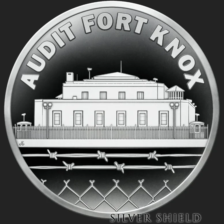 A silver coin featuring Fort Knox with the text 'AUDIT FORT KNOX' around the top edge and 'SILVER SHIELD' at the bottom. The design includes a depiction of Fort Knox, barbed wire, and fence details.