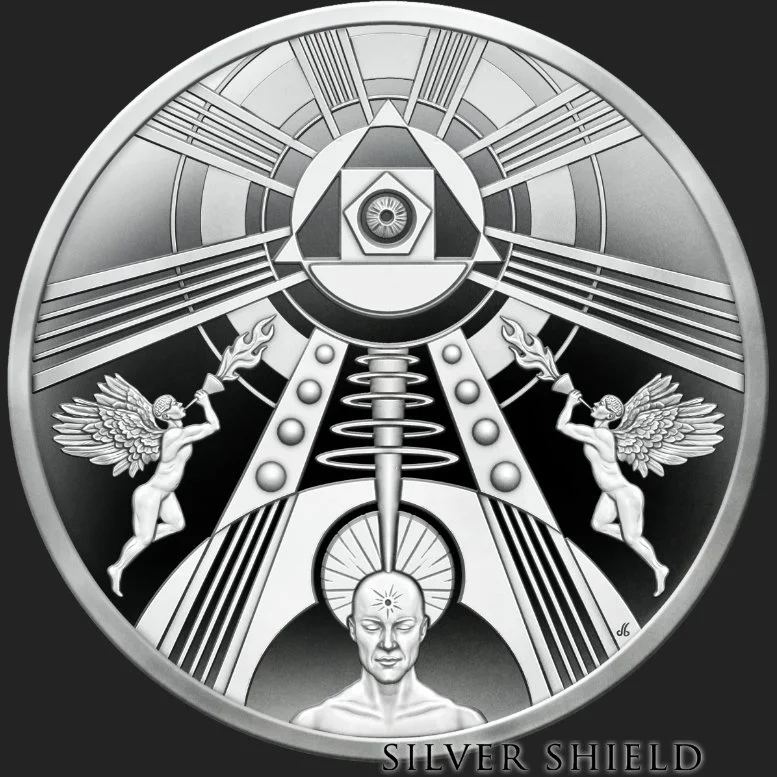 A minted silver proof coin with a metallic, futuristic design featuring two winged humanoid figures holding torches, a human head with a symbol on its forehead, and geometric shapes with radiating lines, titled 'Silver Shield'.