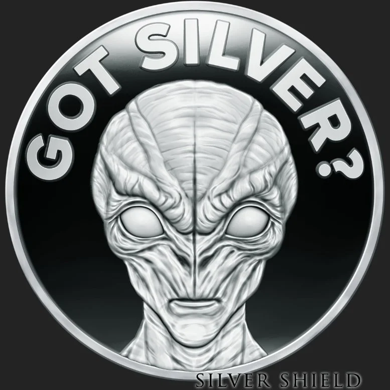 A minted silver proof coin with an alien head with large eyes and detailed facial features inside a circular frame. Text around the top reads "GOT SILVER?" and at the bottom reads "SILVER SHIELD."