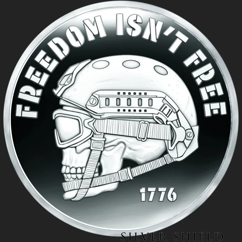 Silver coin featuring a skull wearing a military helmet and goggles, with the text 'FREEDOM ISN'T FREE' and the year 1776.