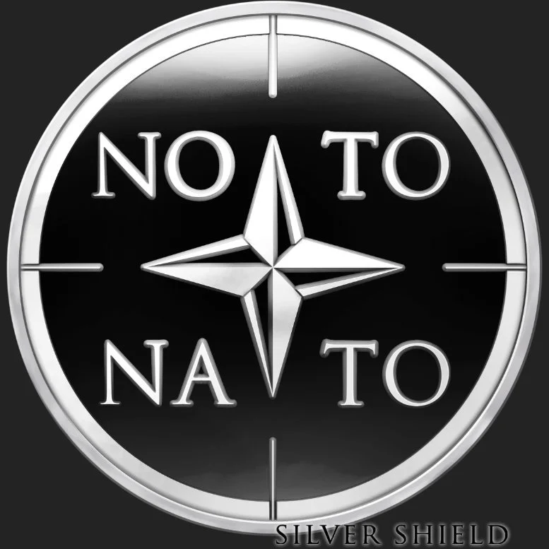 A minted silver proof coin with a compass design. The words 'NO TO' are written above and below the compass, and 'NA TO' are on the sides, with the bottom text reading 'SILVER SHIELD'.