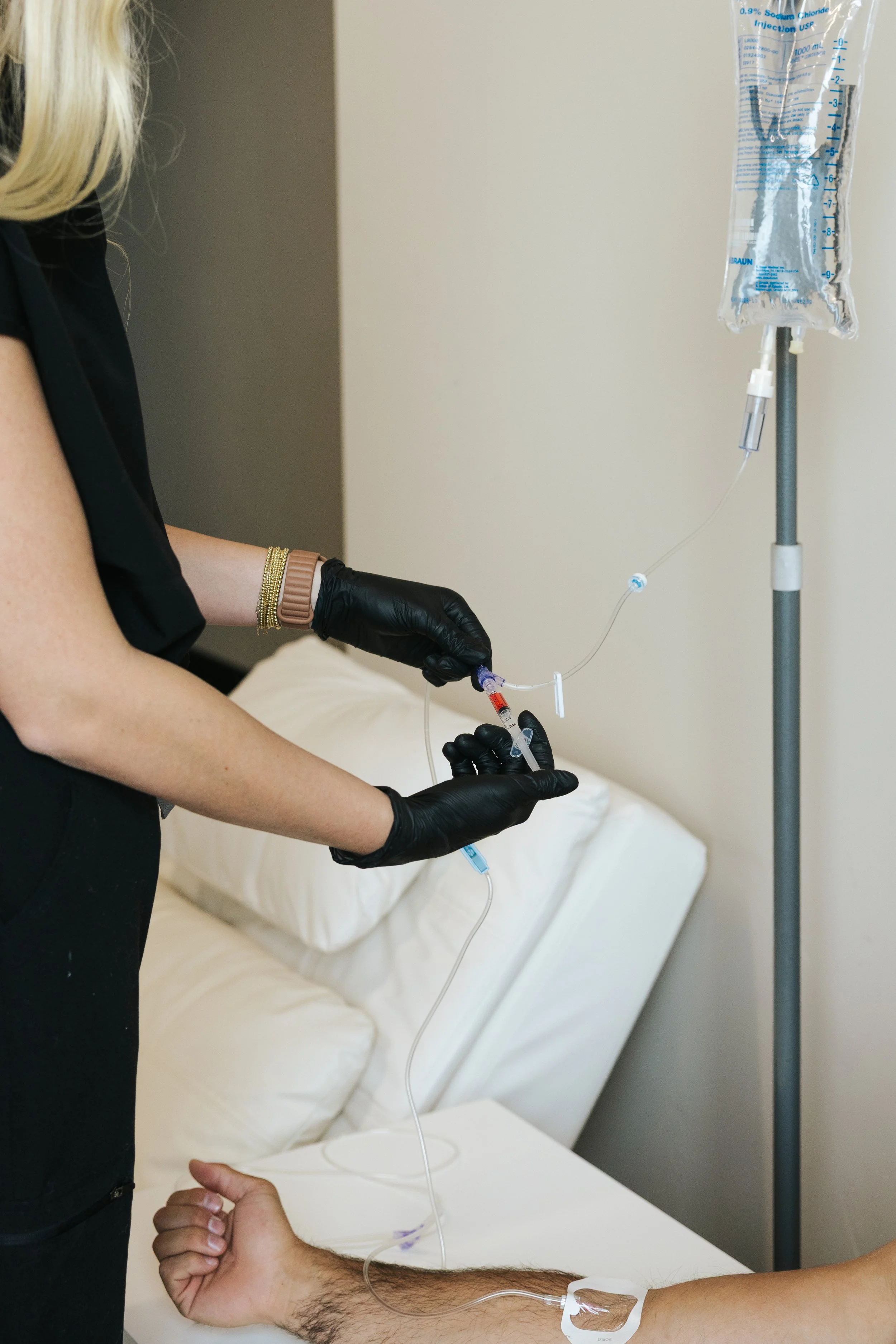 Nurse preparing a mobile IV drip with vitamins before a Provo home visit