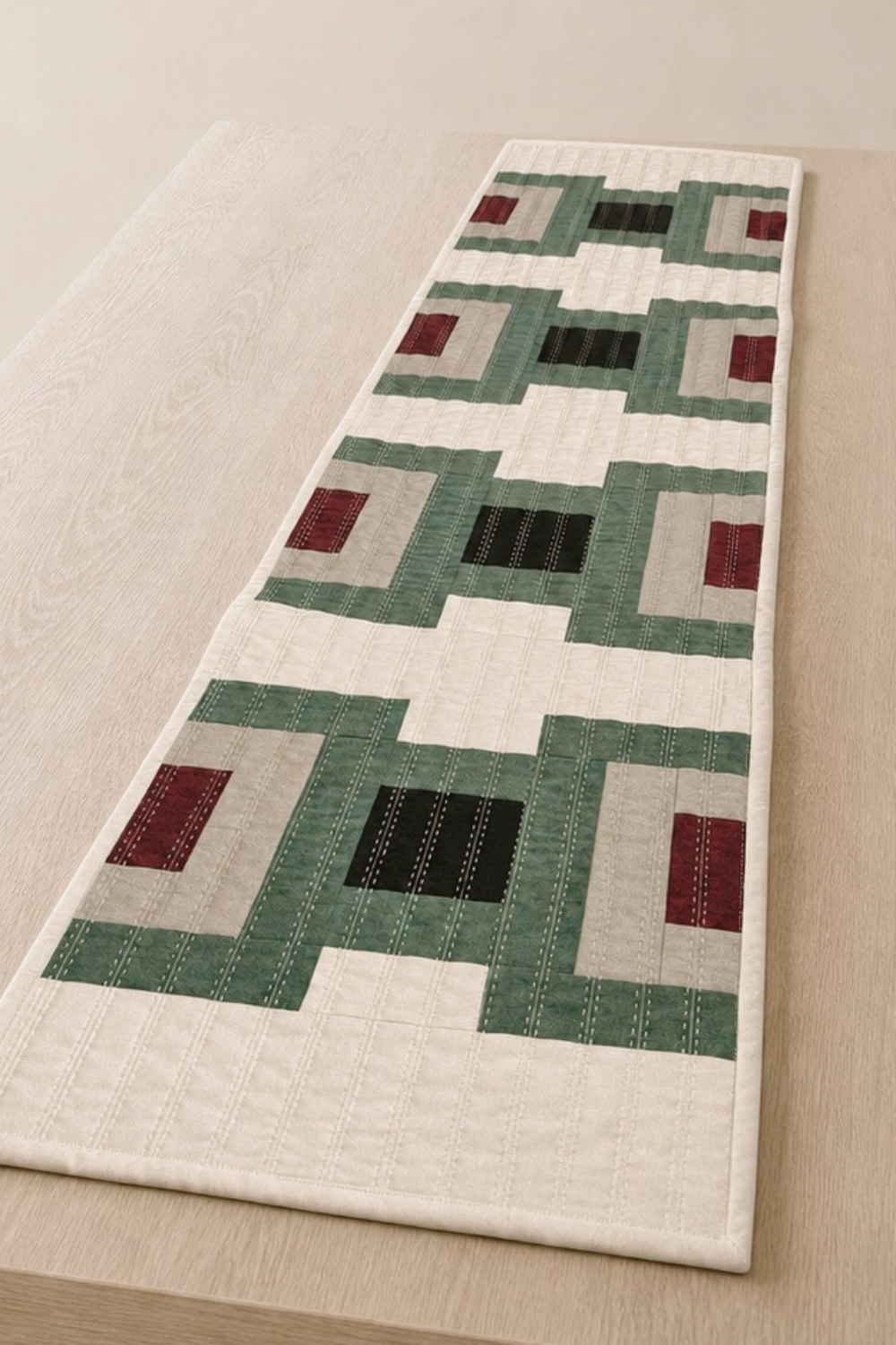 Style your table with the Cruce quilted table runner pattern, a modern DIY décor project featuring geometric blocks in earthy, inviting colors.