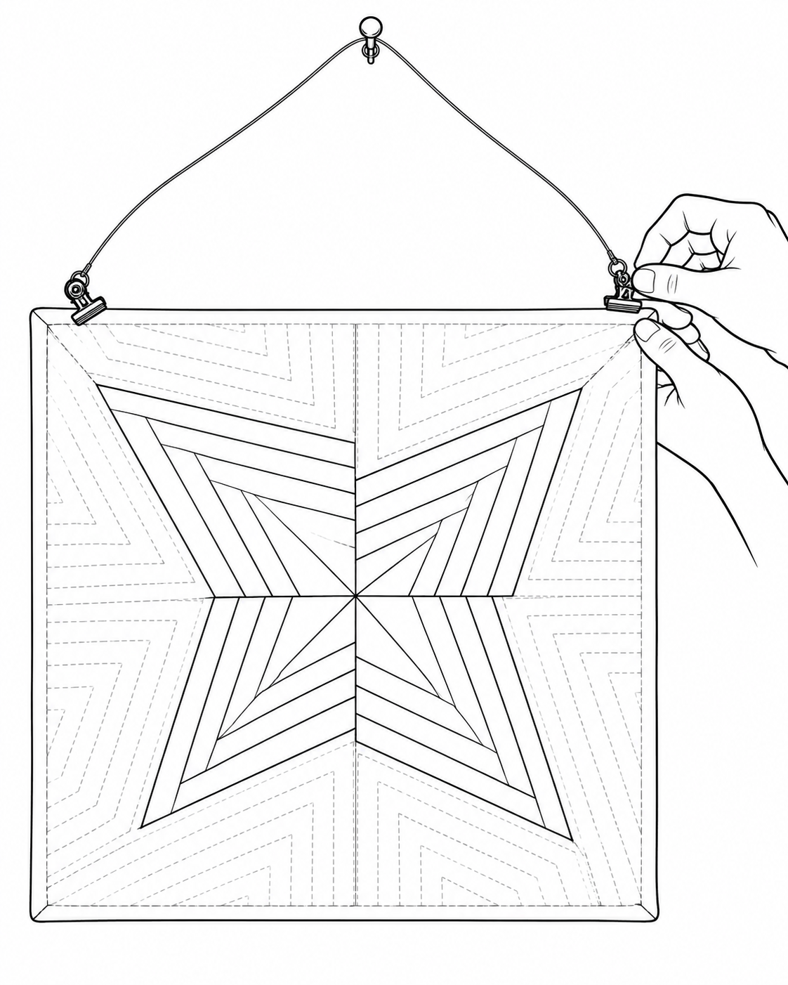Line drawing of hands attaching wire clips to the upper corners of a mini quilt