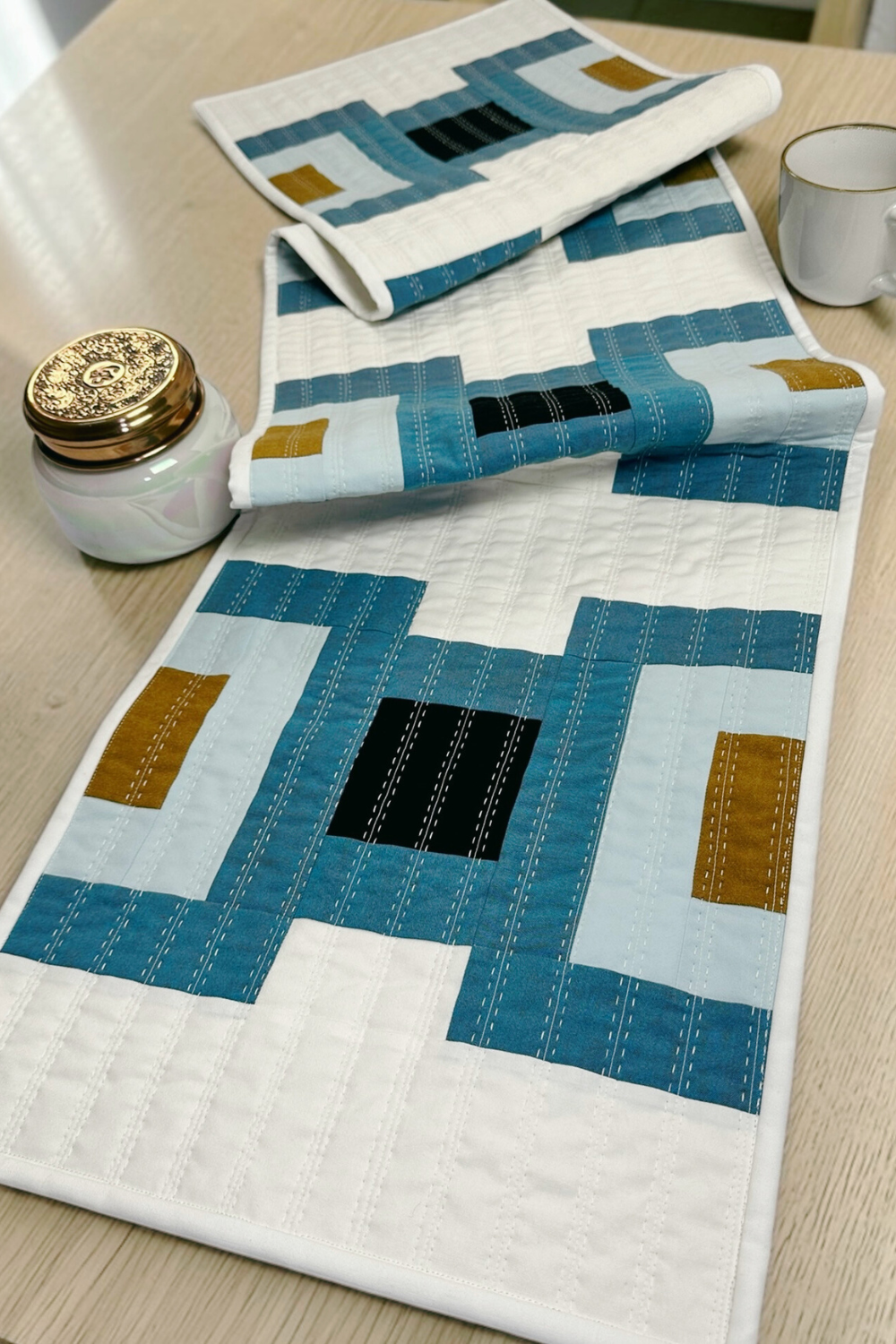 Cruce modern table runner quilt pattern by Kelli Fox Designs, an easy strip-pieced design that comes together quickly