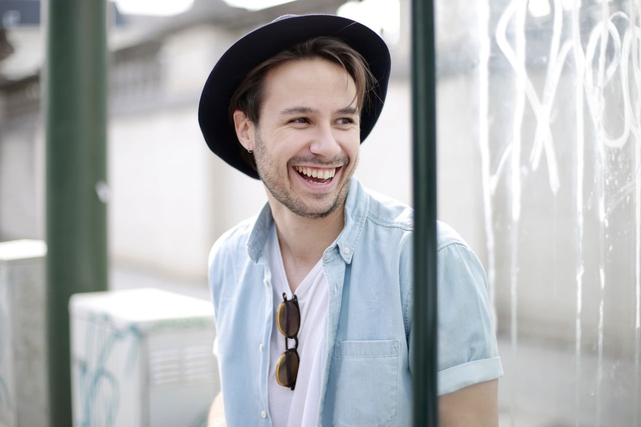 man-in-white-shirt-wearing-black-hat