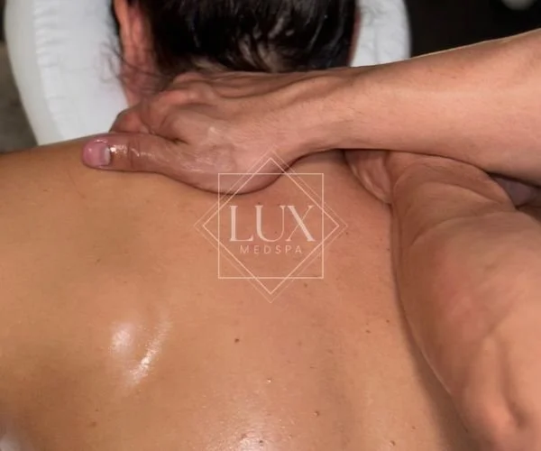 Deep tissue massage treatment focusing on neck and shoulder tension at Lux MedSpa Brickell in Miami
