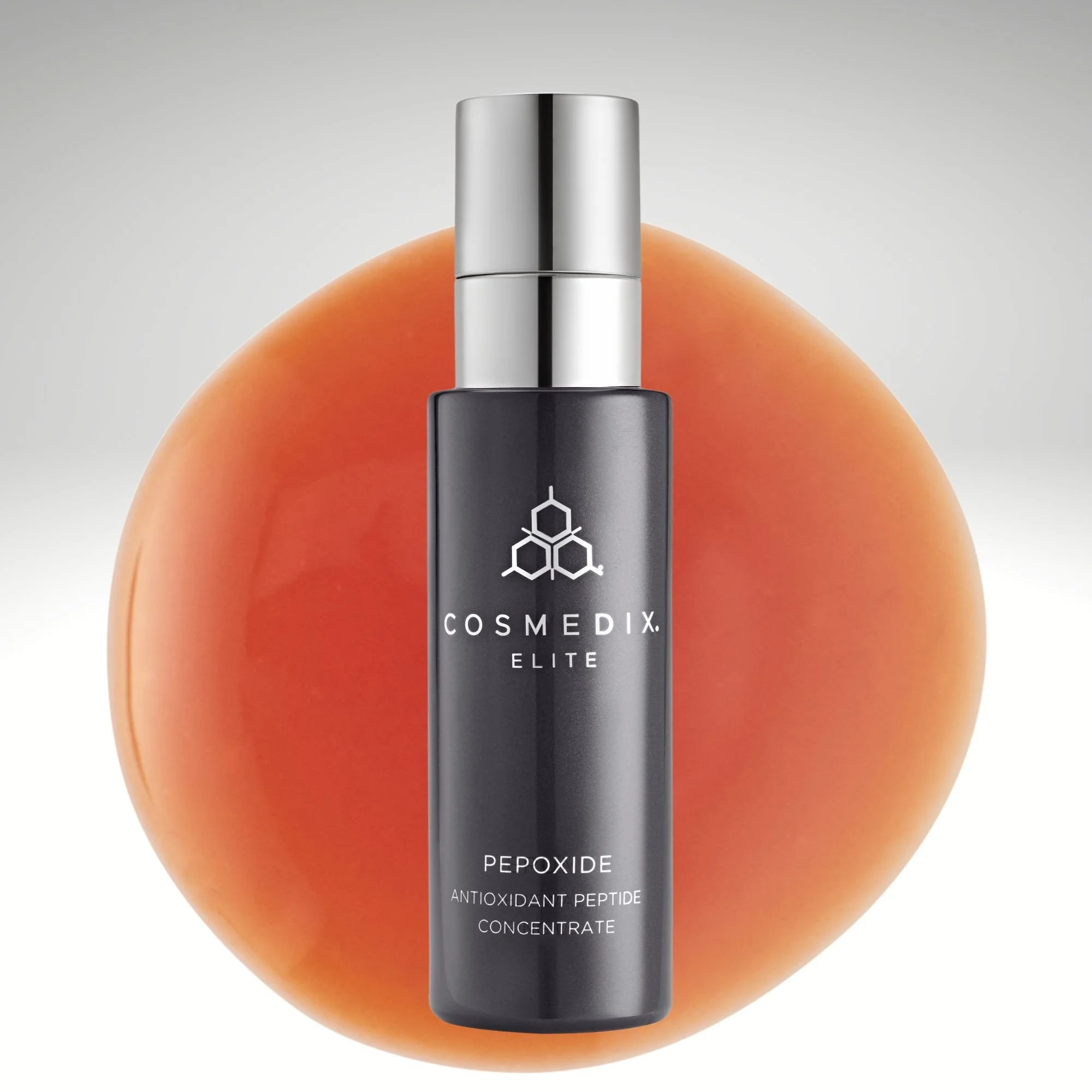 COSMEDIX Elite Pepoxide pump bottle beside three amber serum drops on a round mirrored surface.