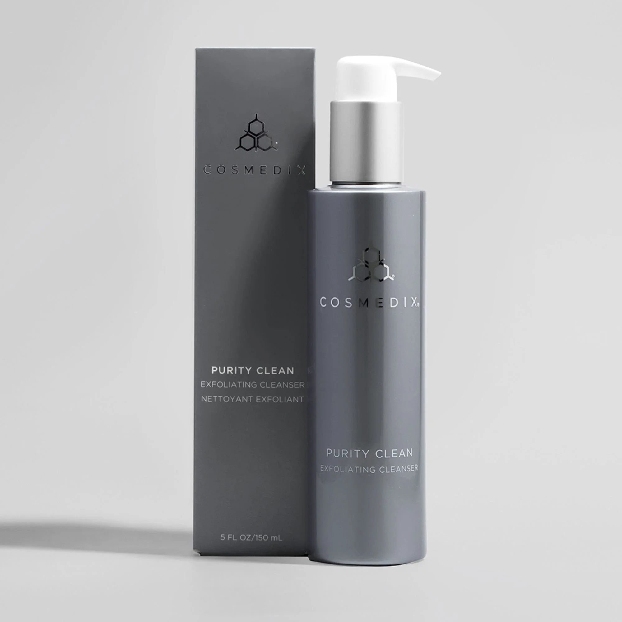 COSMEDIX Purity Clean Exfoliating Cleanser bottle displayed beside its original product packaging.
