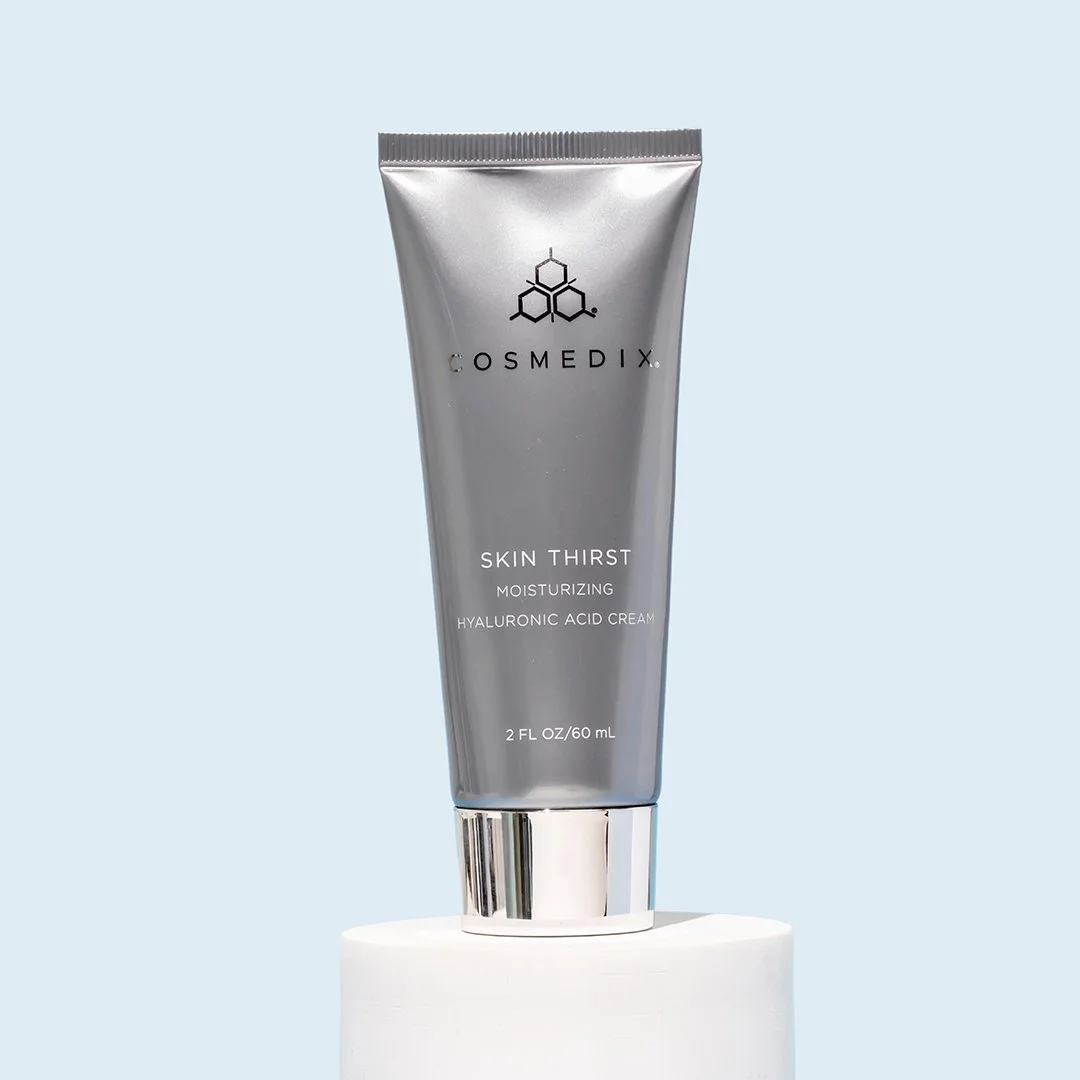 COSMEDIX Skin Thirst 60 mL moisturizer tube beside its box on a light gray surface.
