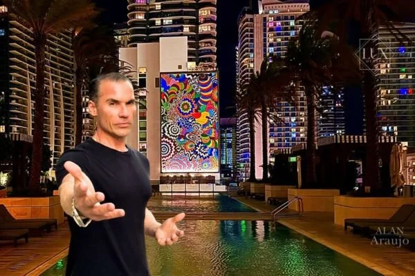 Alan Araujo, founder of Lux MedSpa Brickell, standing in front of the SLS LUX pool in Miami