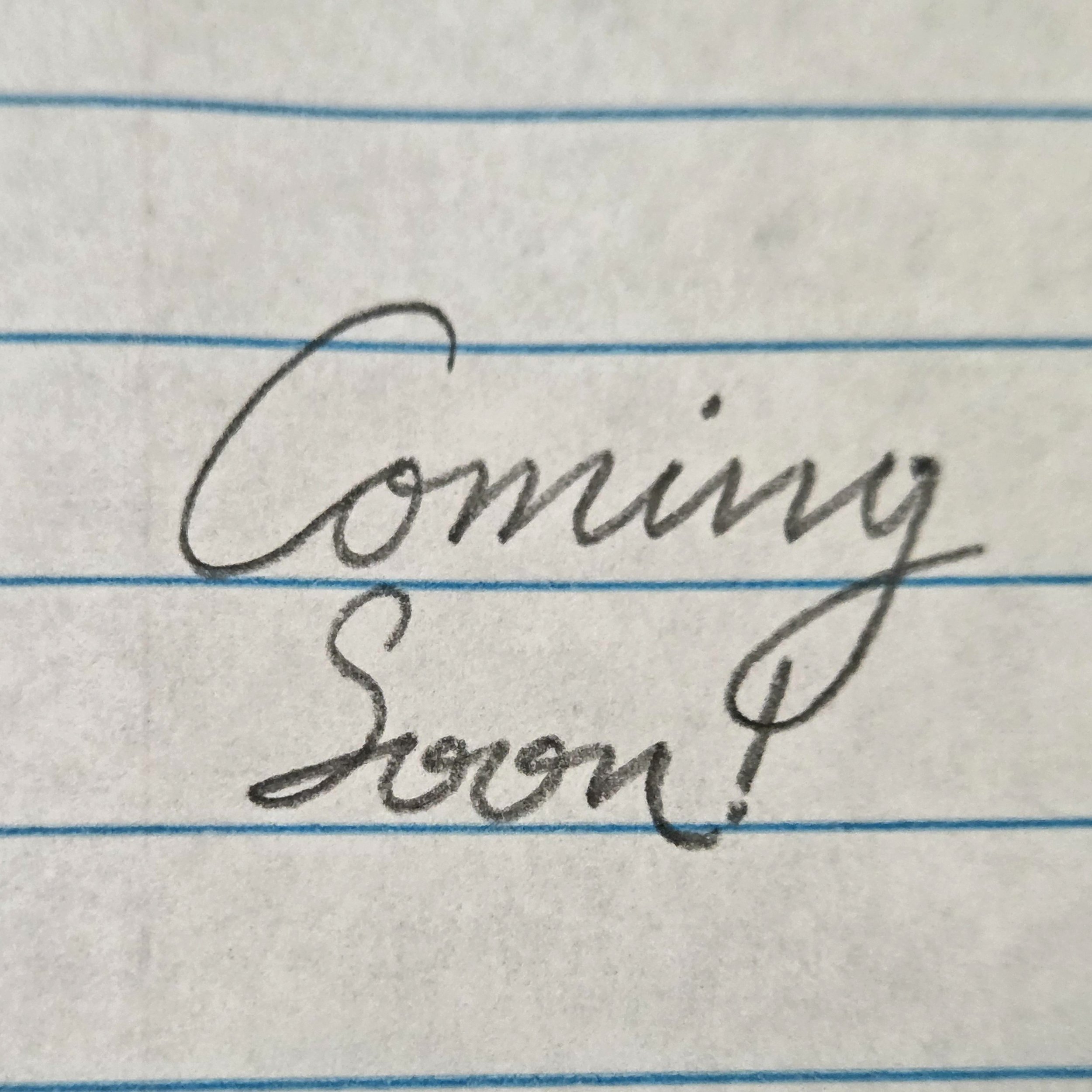 cursive handwritten text reading "coming soon!"