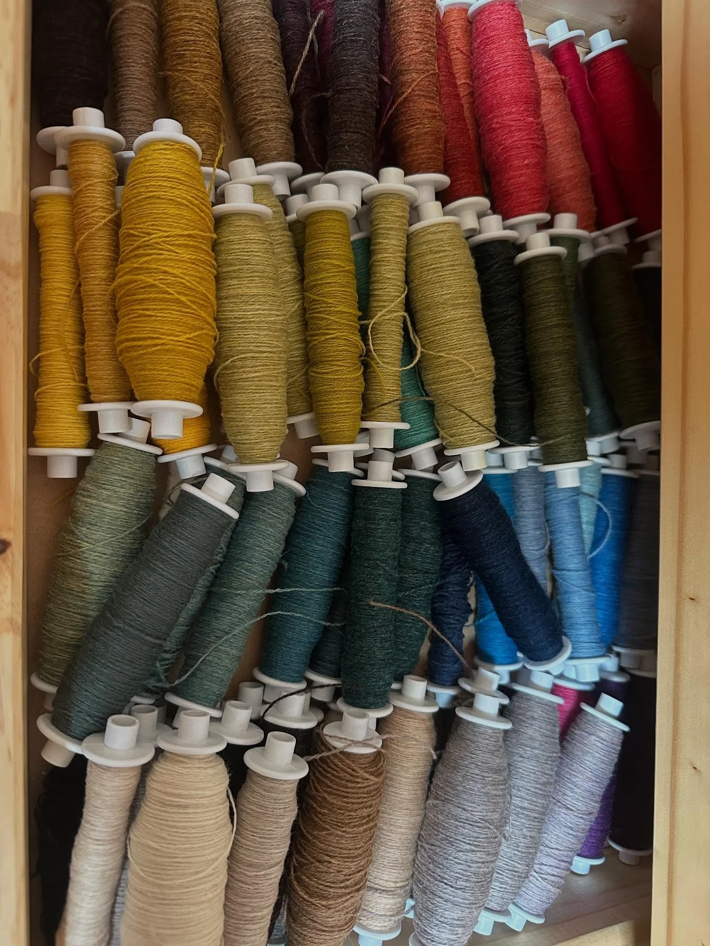 Lambswool bobbins waiting for their chance to be useful.