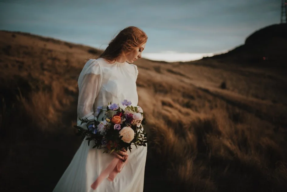 bride in a port hills breeze during her elopement bride in a port hills breeze during her elopement